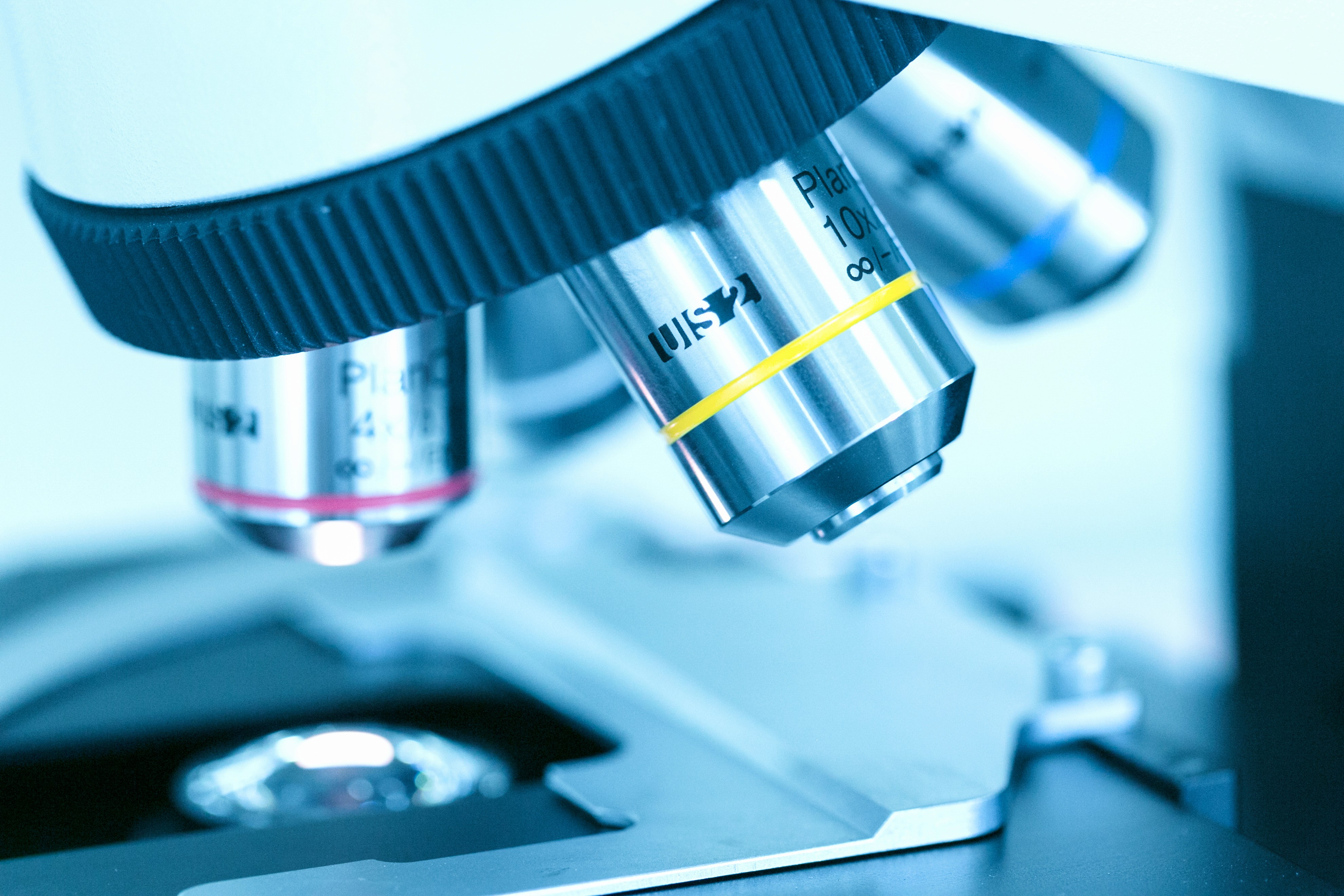 Close-up of a microscope's objective lenses, showing scientific research tools.