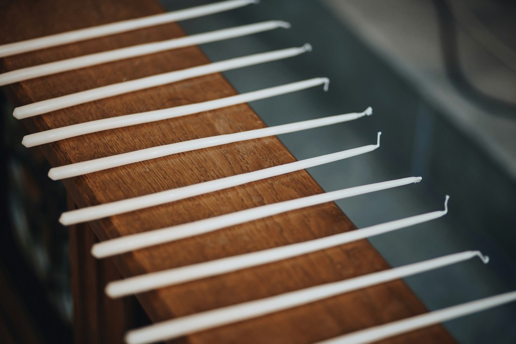 a row of toothbrushes sitting on top of a wooden table