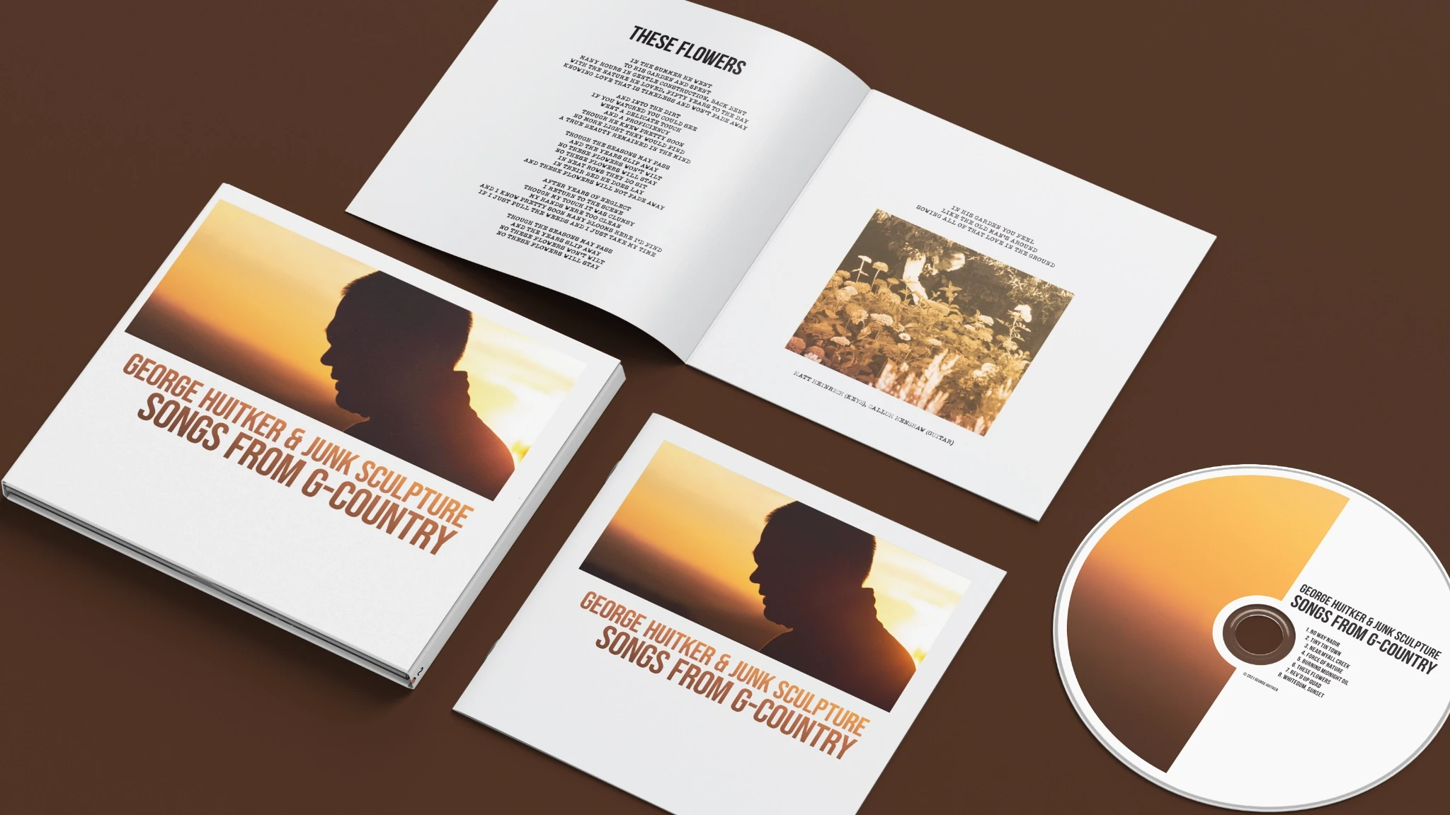 Elements of an album titled Songs from G-Country, including album artwork, a printed disc, and a booklet open to a page with song lyrics for These Flowers.