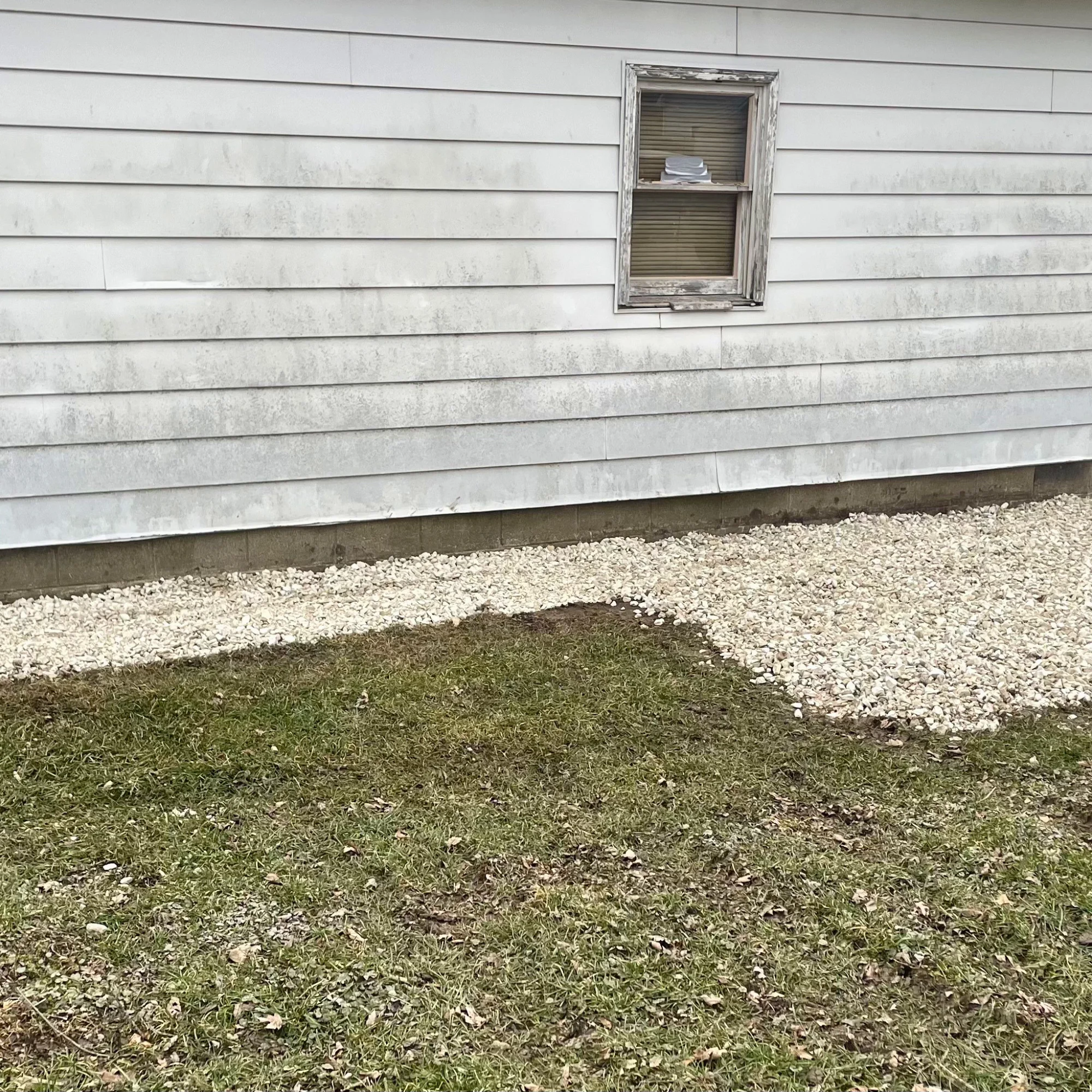 a yellow excavator on a hill with a blue sky in the background