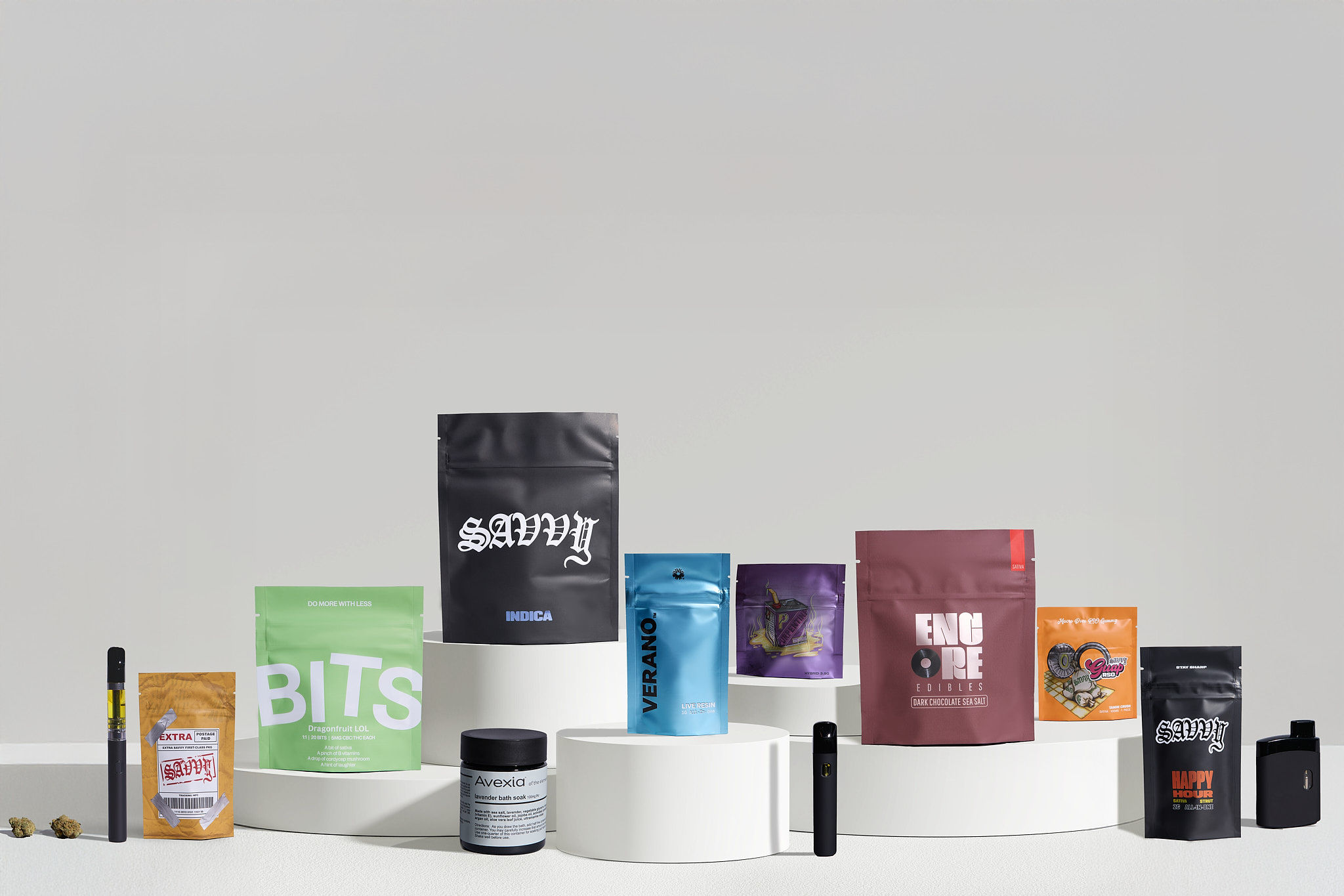 A crow perched on a pipe against an orange sky.