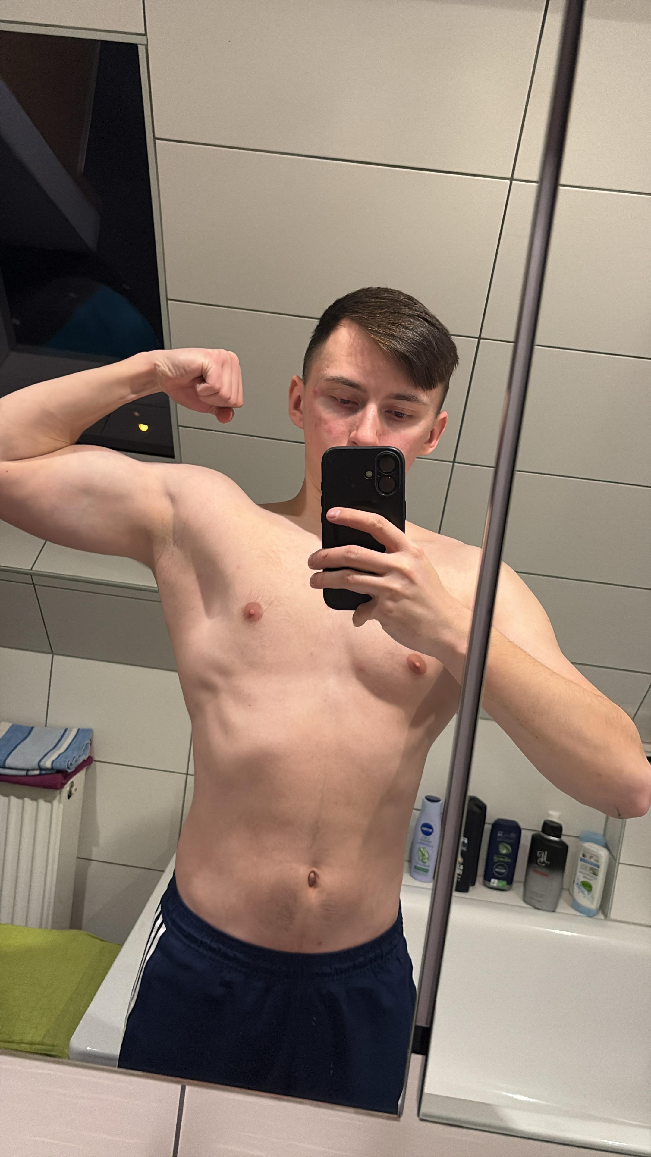 greyscale photo of woman in bralette inside room