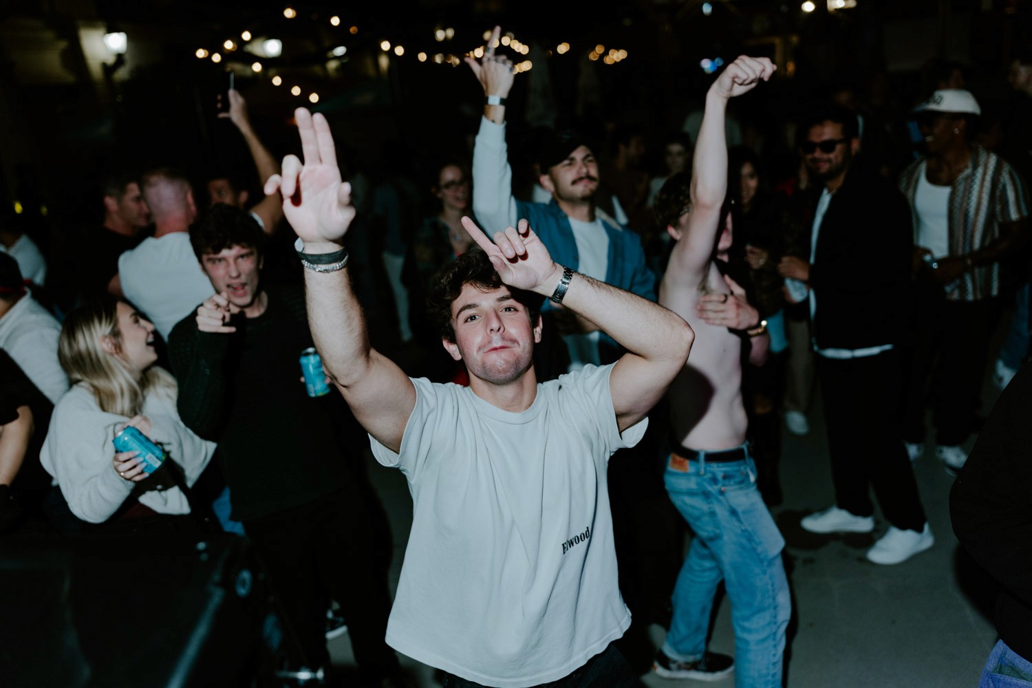 Dancers raise their hands in the Millennium Hall beer garden.