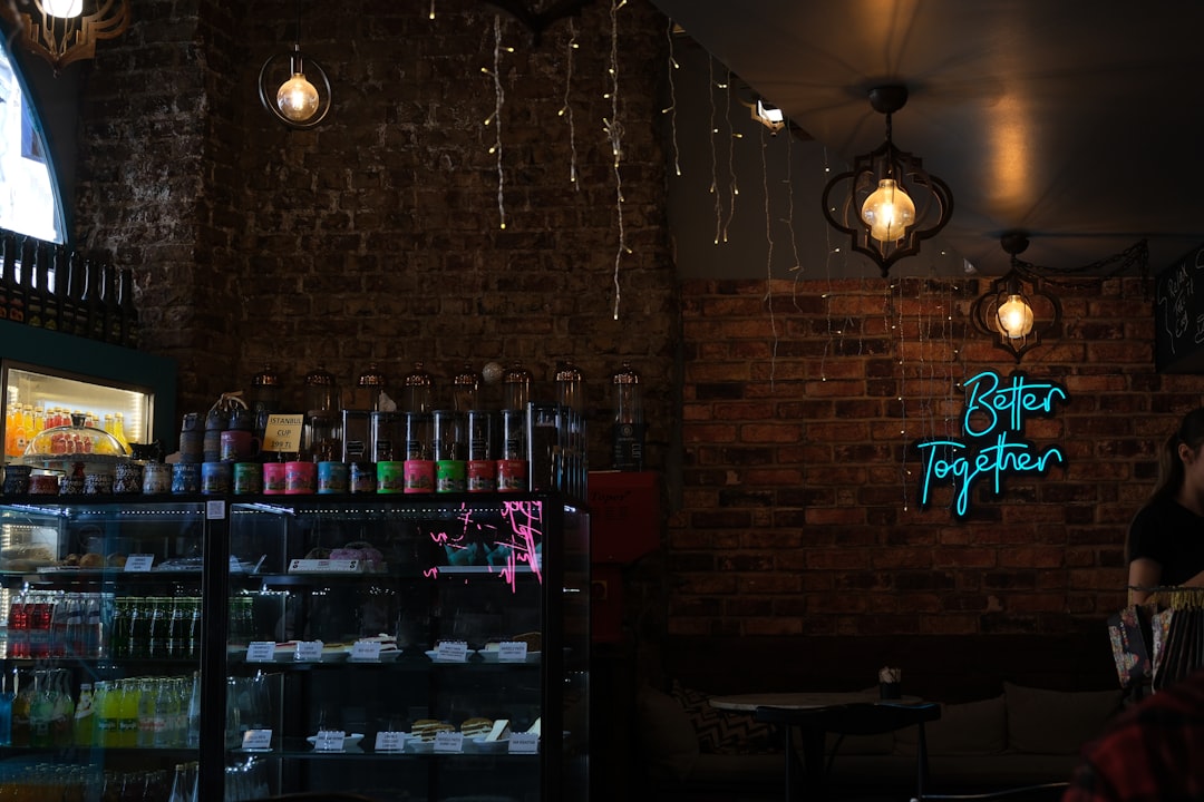 Cozy cafe interior with neon sign and brick wall
