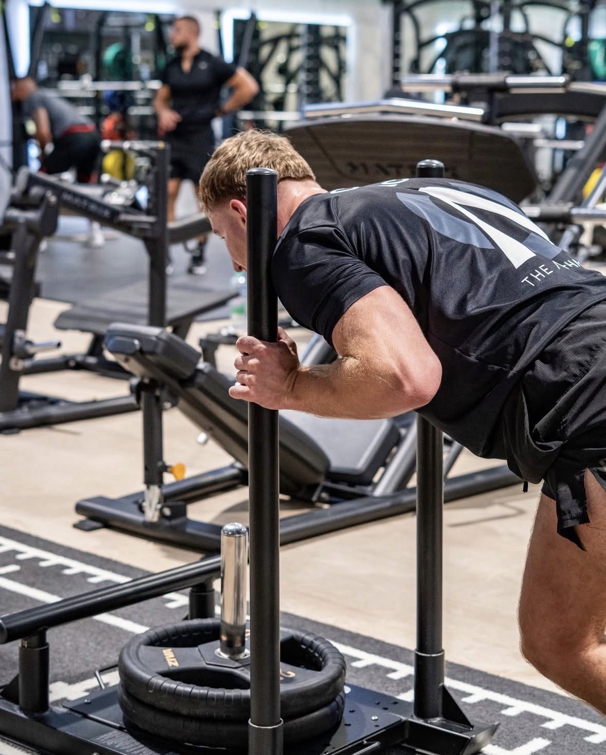 Photo of Evo X founder Deri Morgan seated outdoors at sunset with ocean view in the background