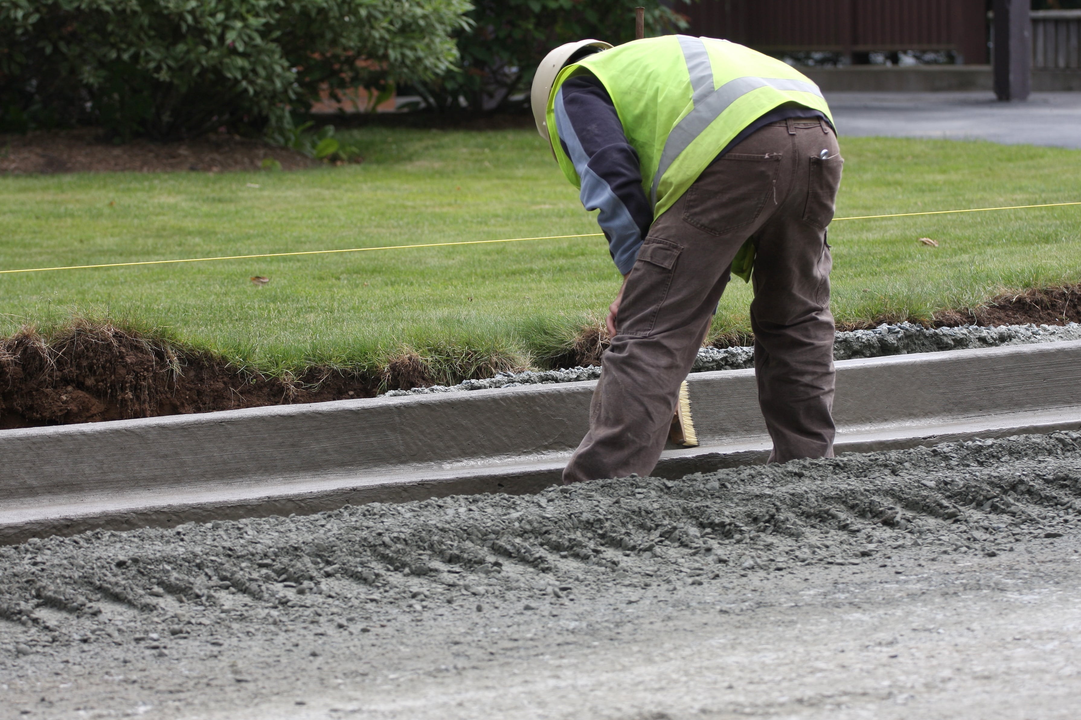 Concrete site work by Gridmark, showing newly installed curbs and parking stops, ensuring safe traffic flow and pedestrian safety in Smithfield, Virginia