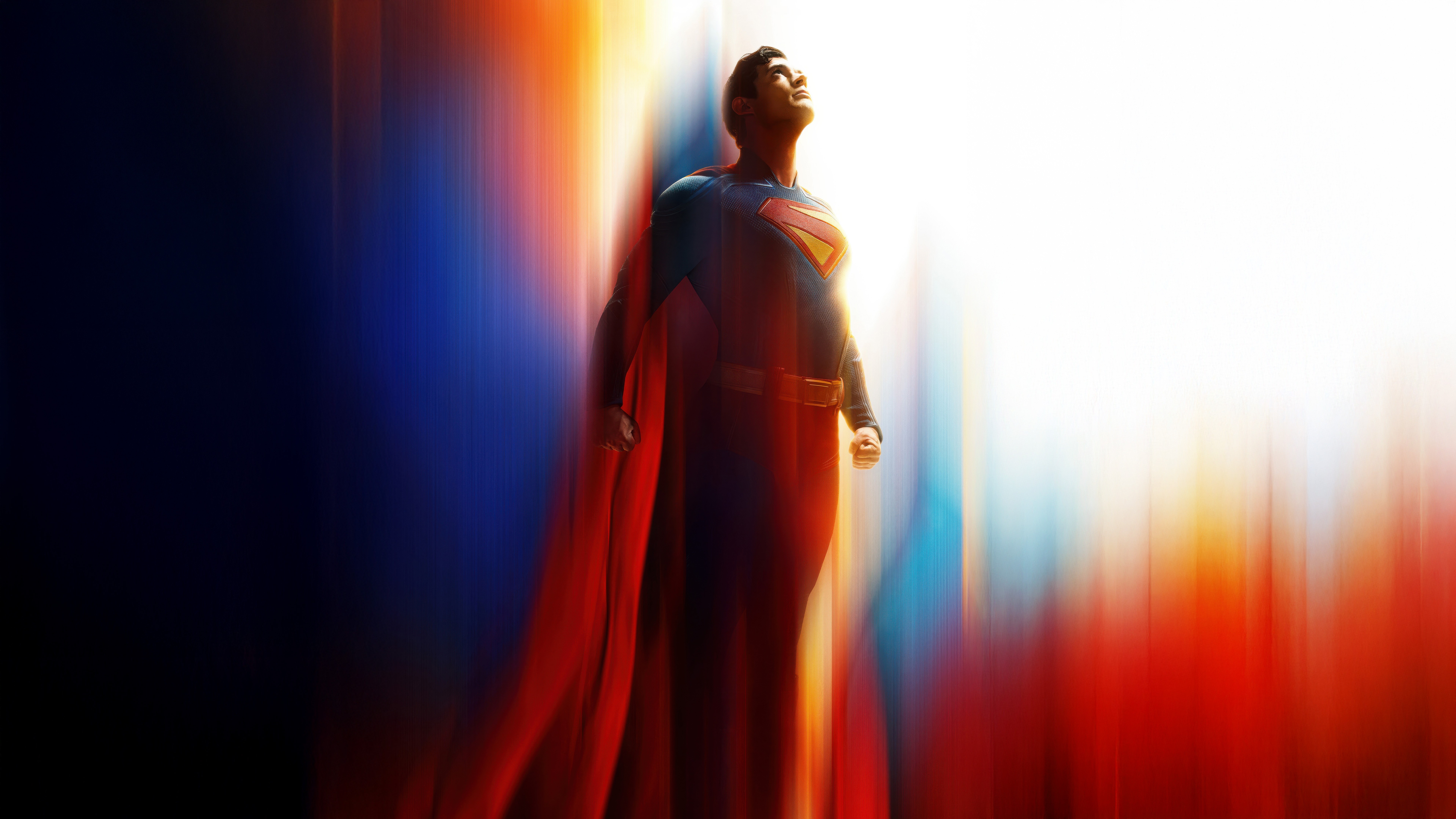 David Corenswet as Superman in his blue suit and red cape flying upward while stripes of light flash past him.