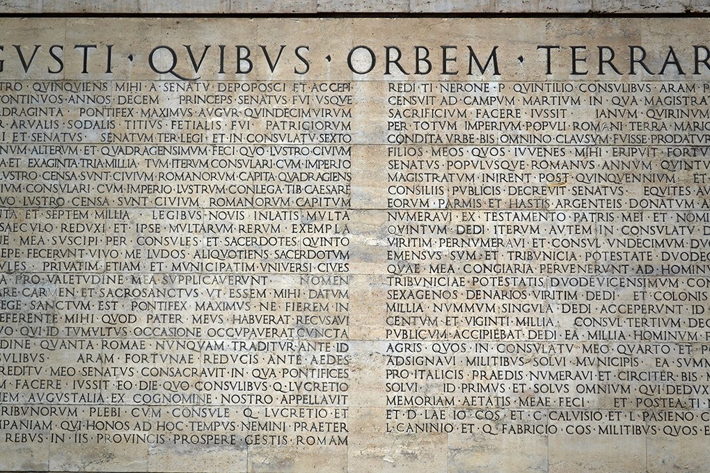 a wall with engraved text on it