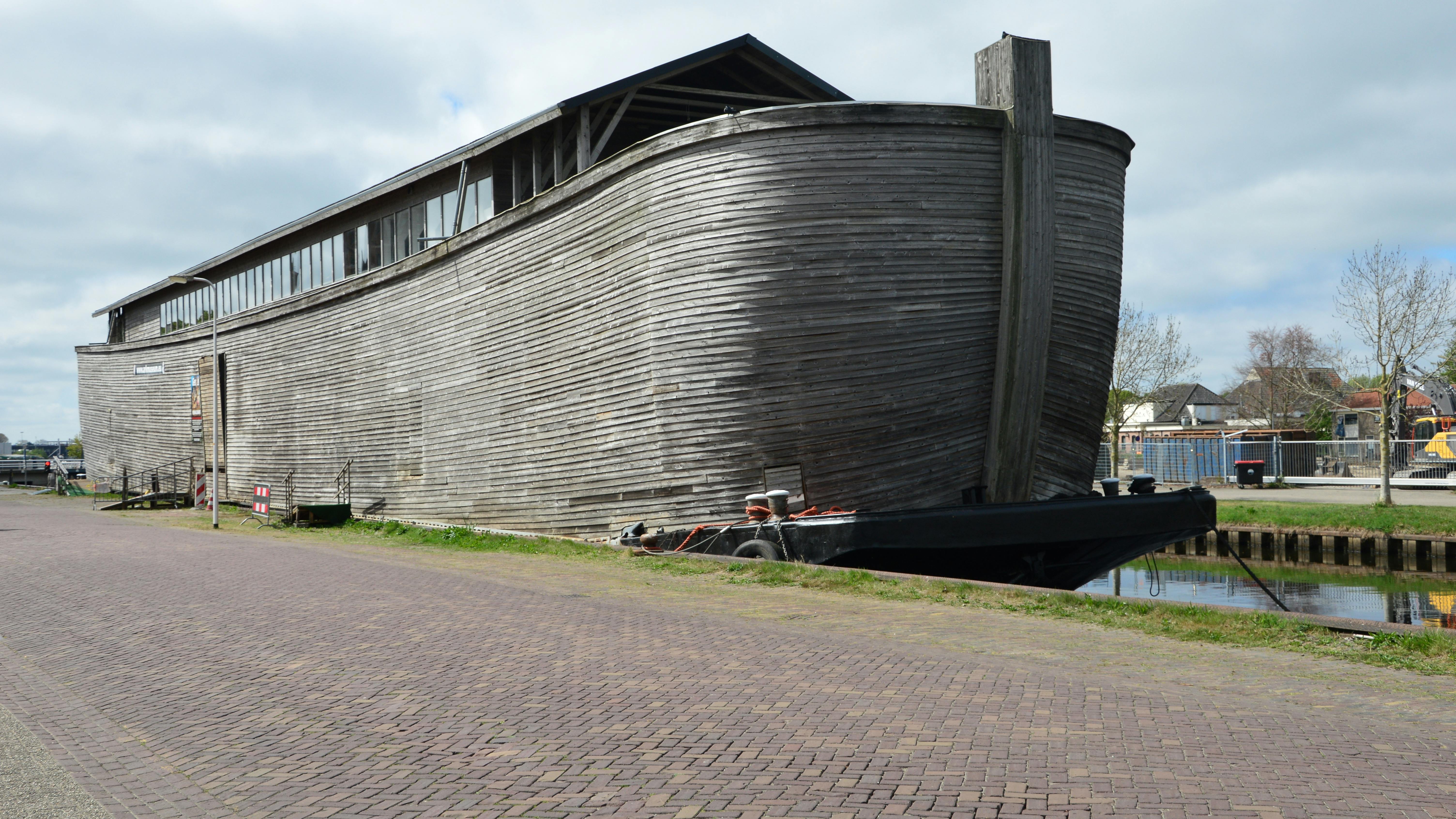 Noah's ark floats on the water with animals.