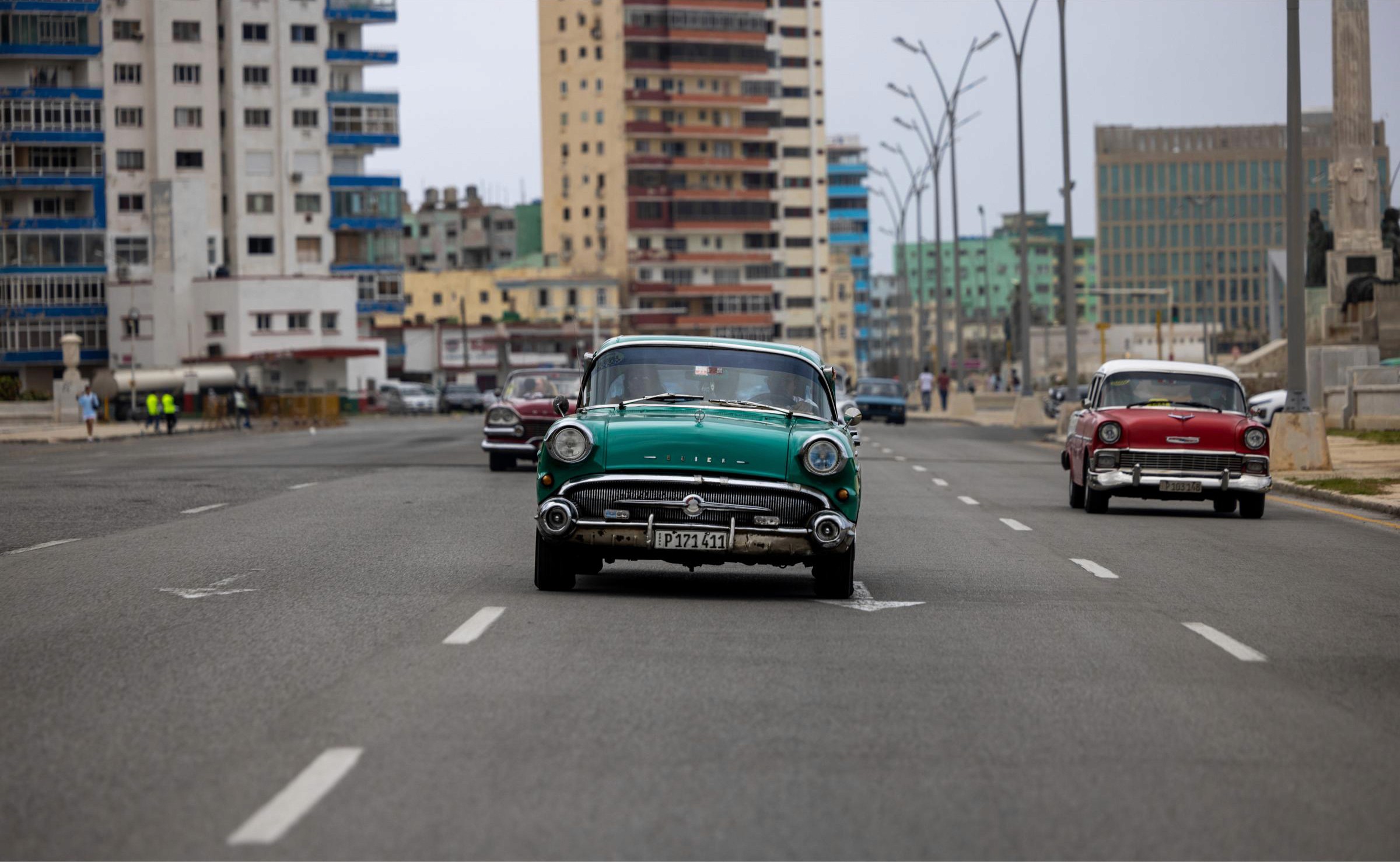 A 1957 Buick Roadmaster crusies behind us on the Avenida Malecón.