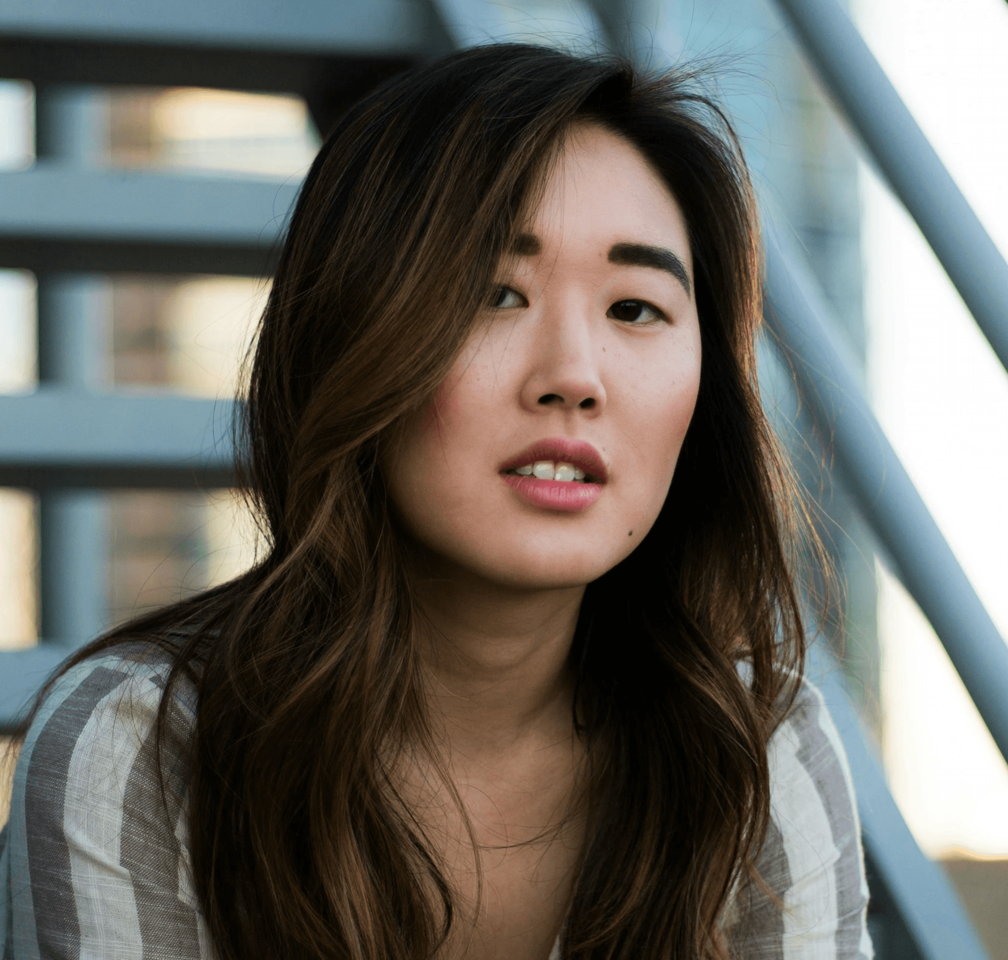 woman sitting on white metal stairs
