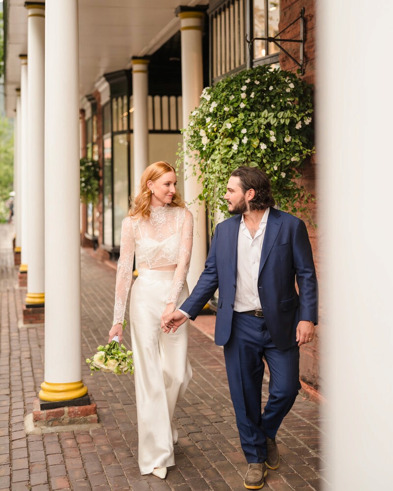 Wedding couple walking together outside an Aspen venue