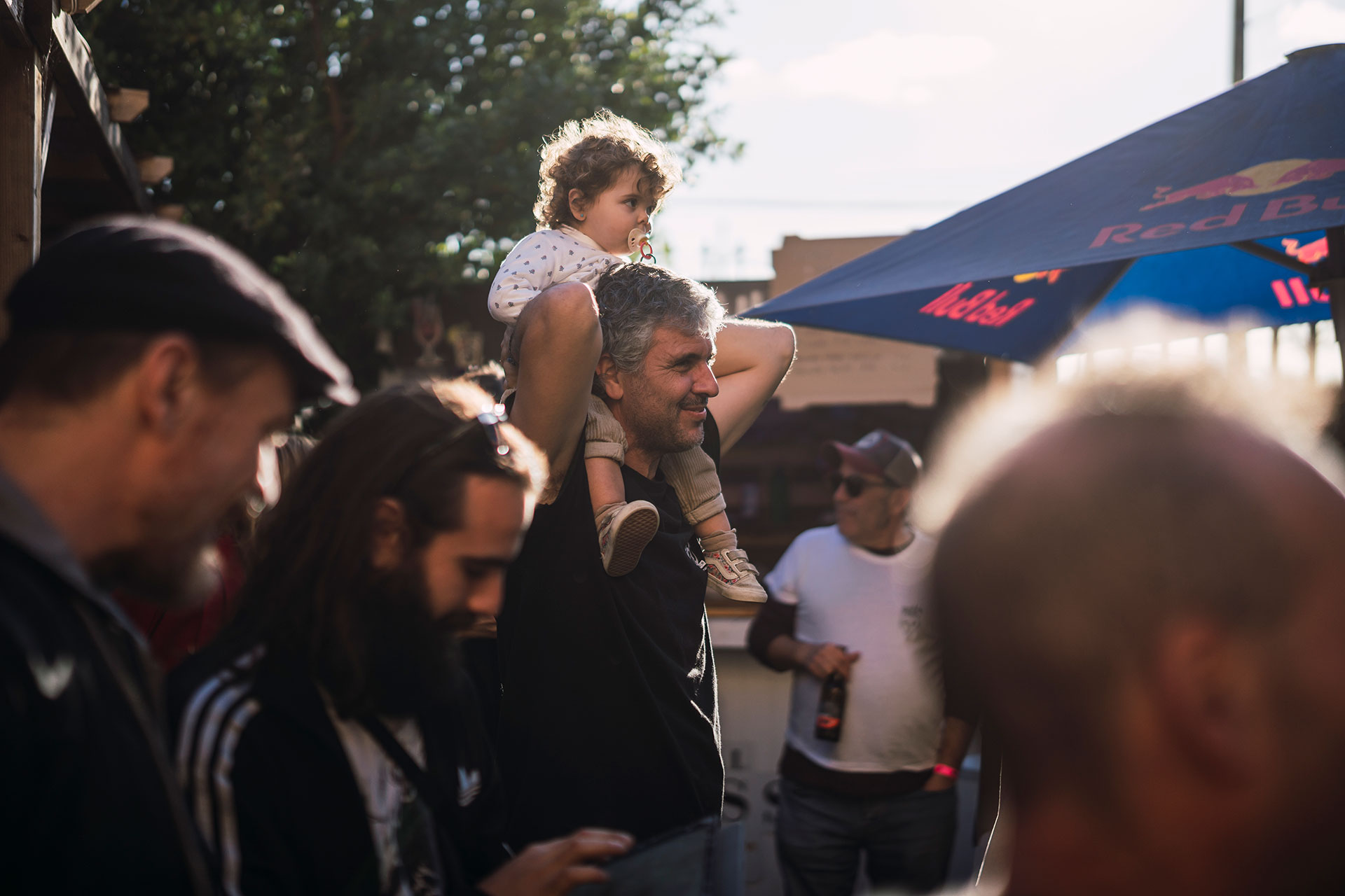 DJ playing music surrounded by dense indoor plants.