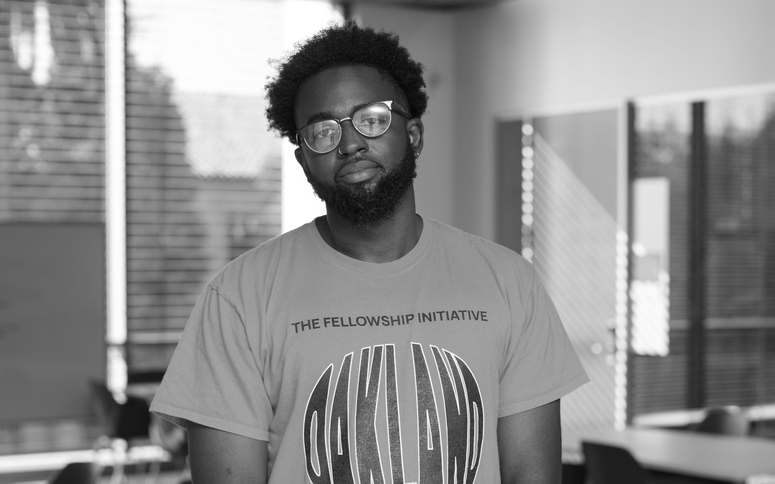 black and white image of a black man looking at the camera
