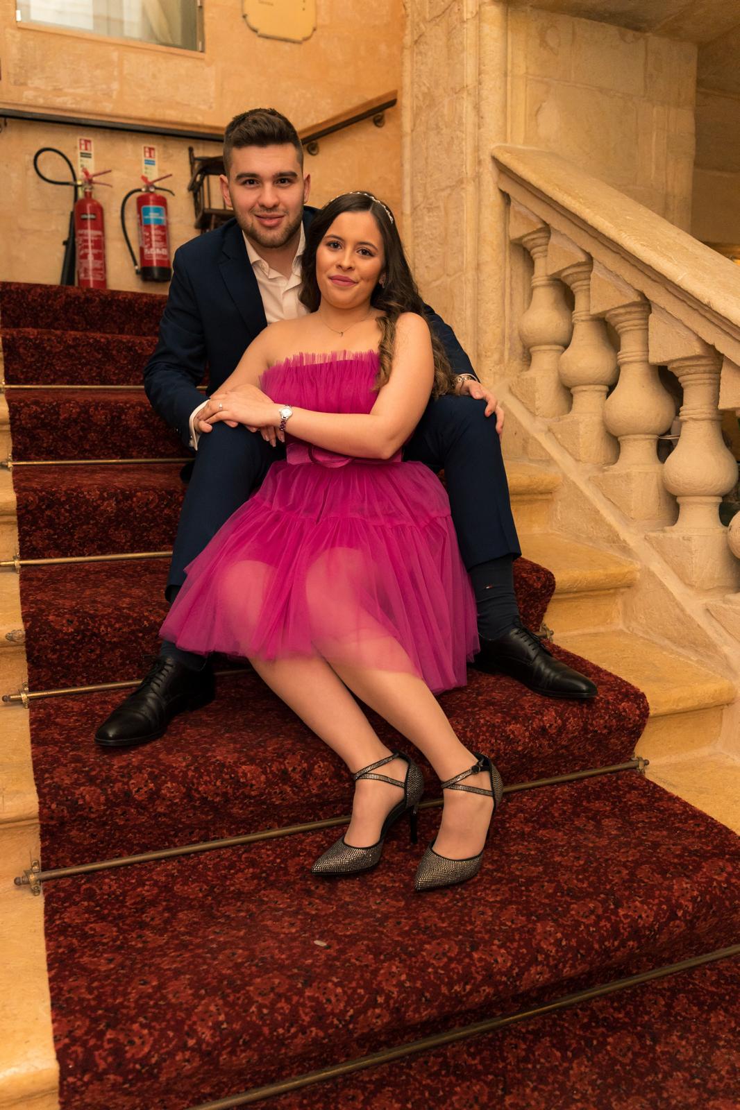 Two gold wedding rings rest atop a soft, textured fabric with a subtle pattern. The rings shine under gentle light, evoking themes of love and commitment.