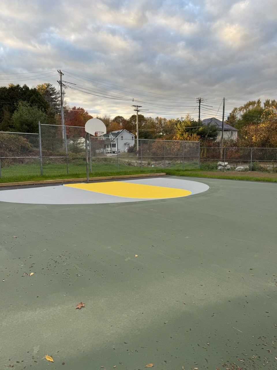 Resurfaced tennis court in green and yellow, by A&M Construction Enterprises