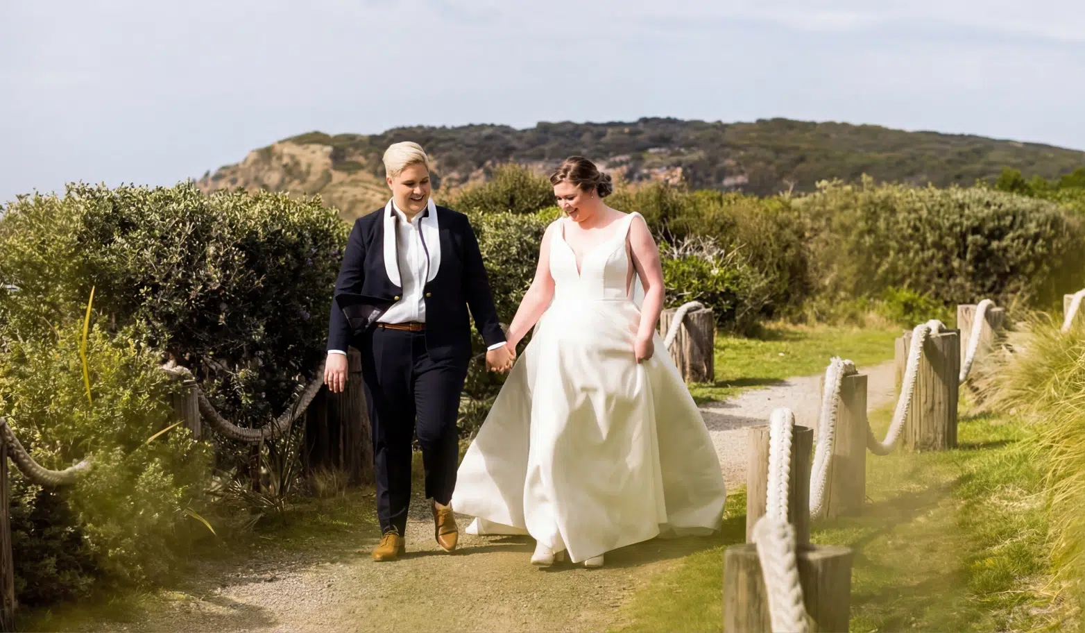 Women’s wedding suit styles in New Zealand with bride in tailored rust suit and modern outdoor ceremony look
