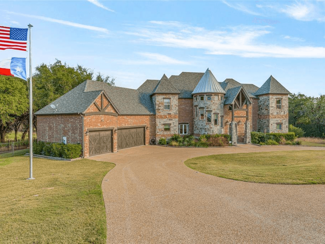 Front of a luxury golf course home at White Bluff Resort with a long driveway and three-car garage