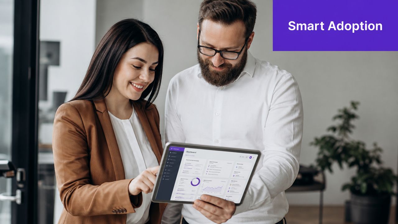 A professional man and woman looking at a business dashboard on a tablet together in an office.