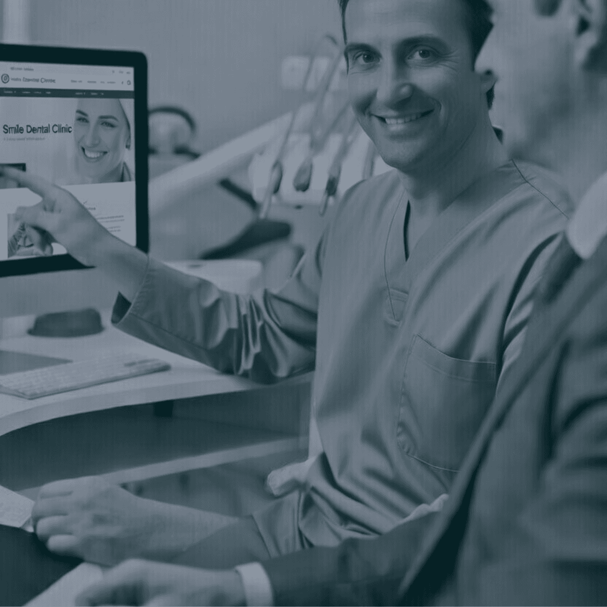 Dentist looking at computer smiling