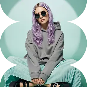a model with purple hair sitting with wearing a black sunglass and a gray hoodie