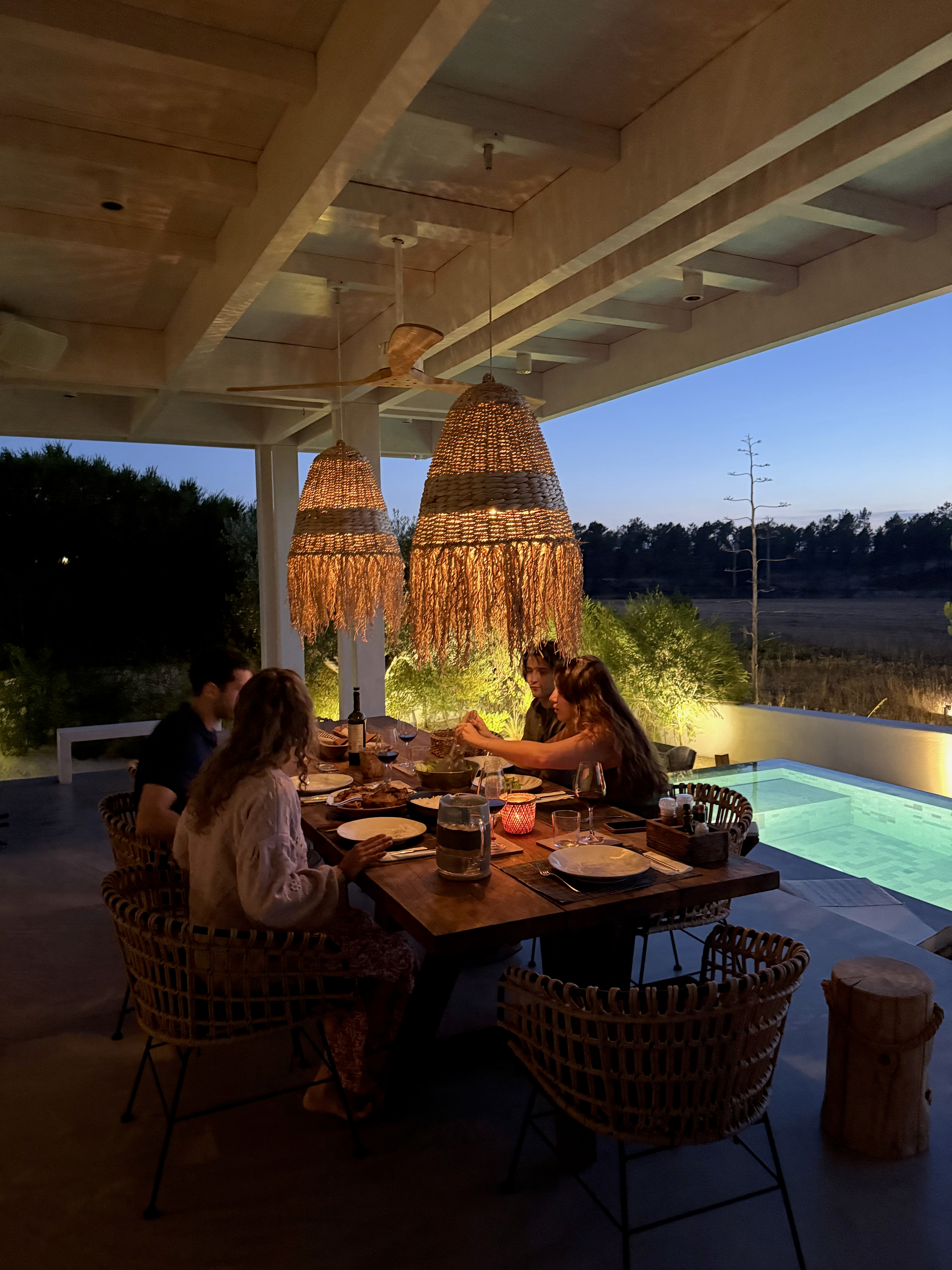 A beautiful young woman smiling at the camera on a mountain field