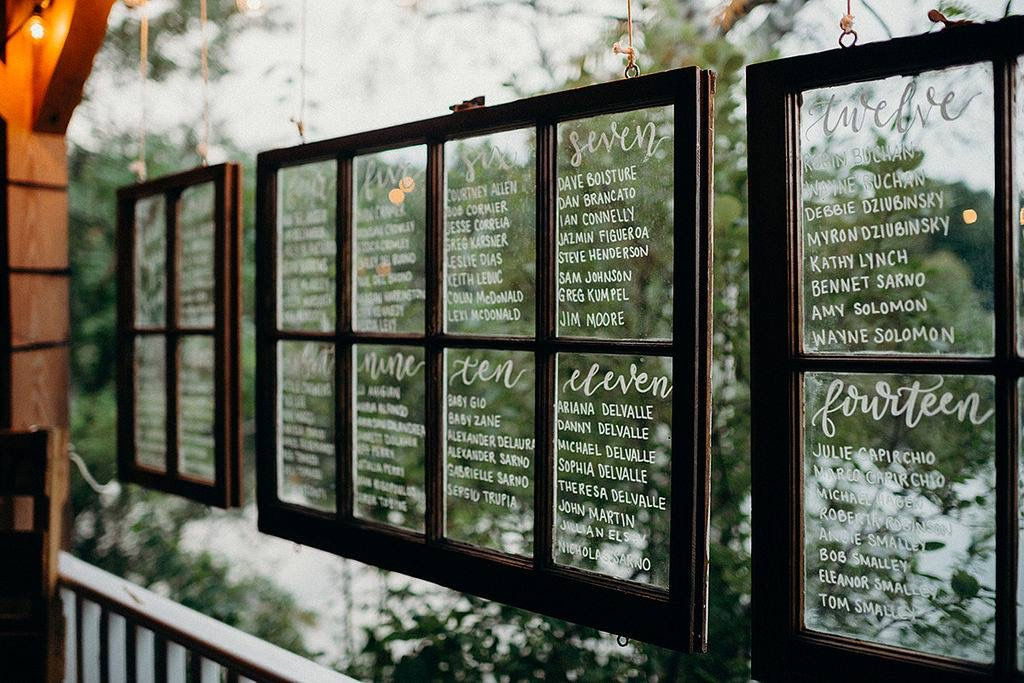 Hand-lettered window seating chart for a wedding at Camp Lenox