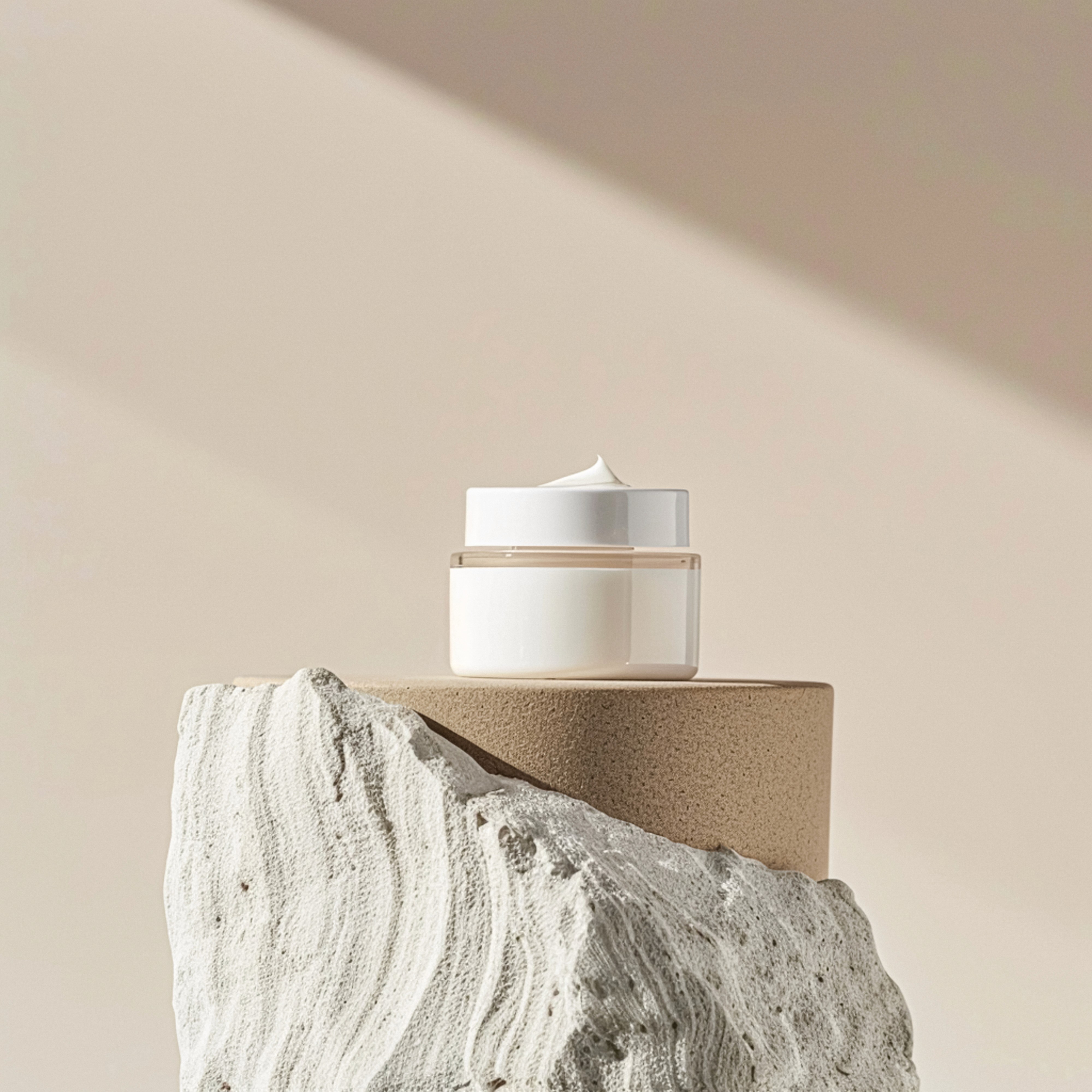 Cosmetic cream in a glass jar on a platforom for display.