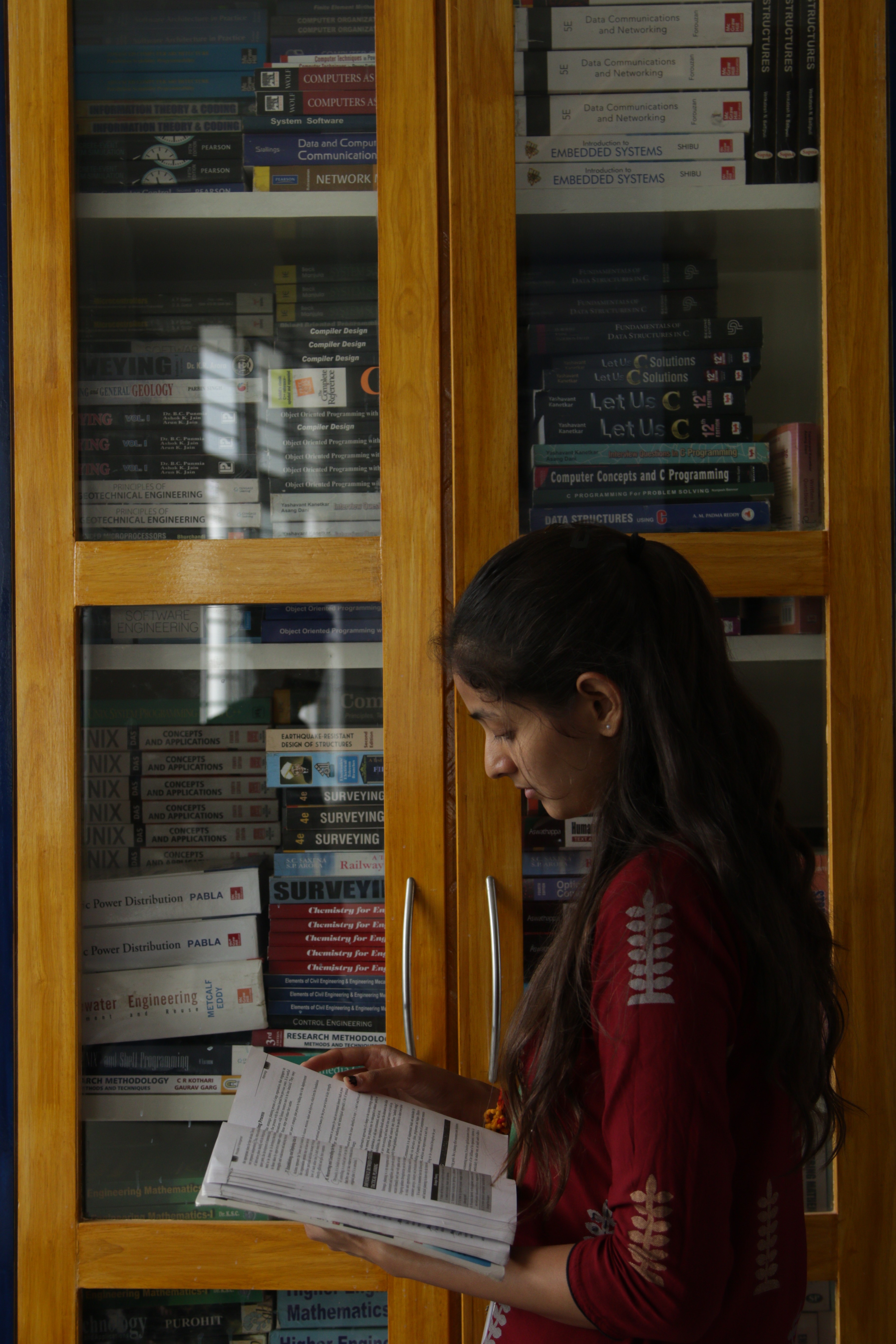 woman in black shirt holding green and blue plastic toy
