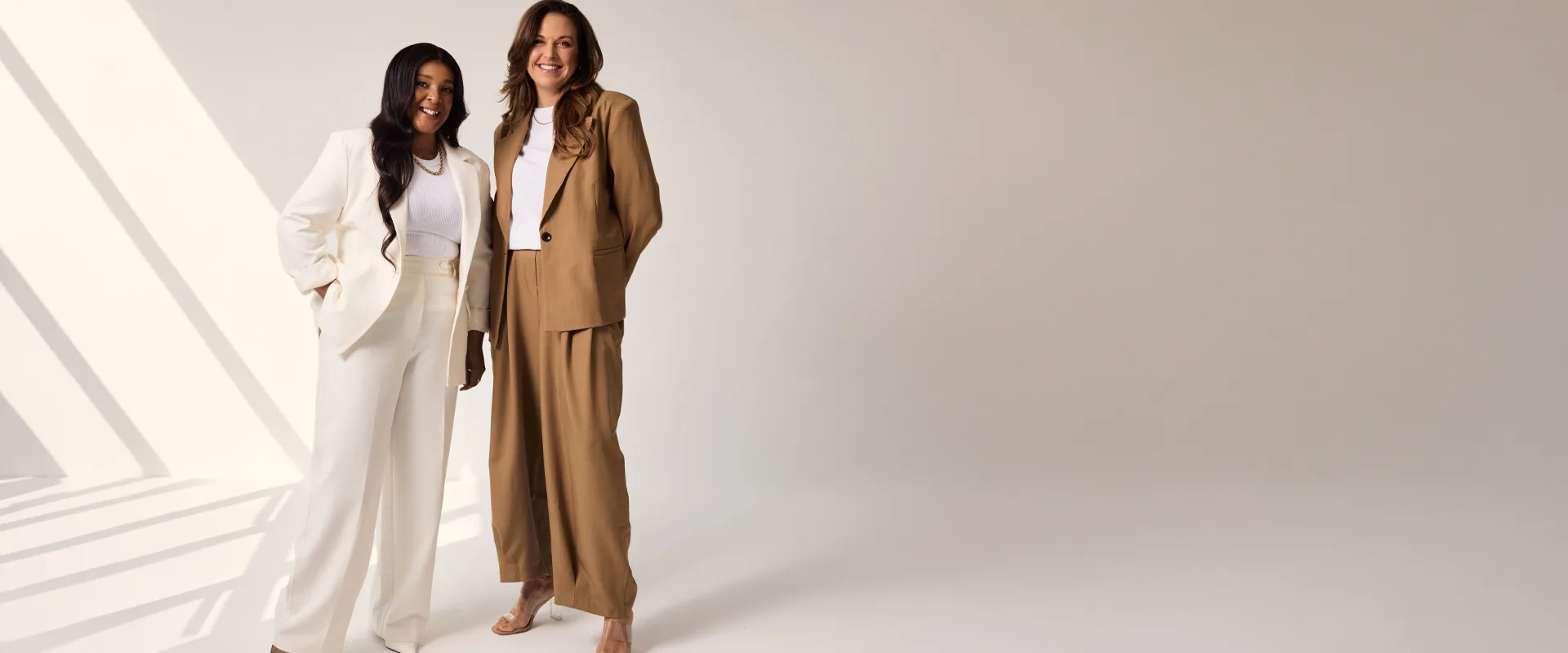 Sēkret founders Roz and Zola standing side by side in a bright studio