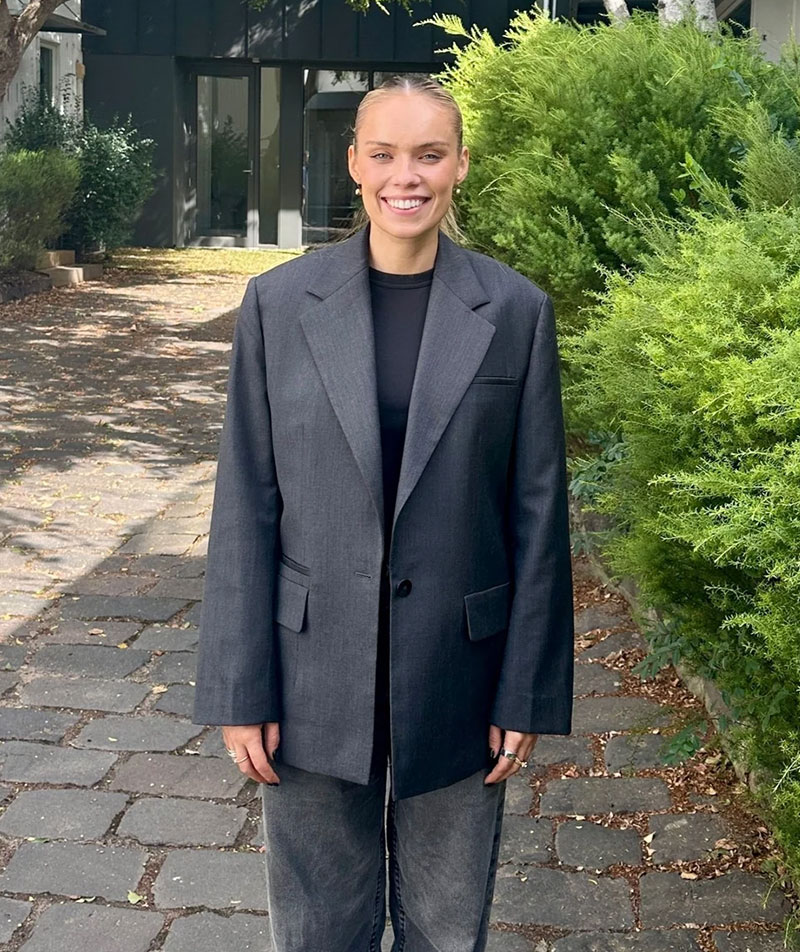 A profile image of Brandy Dixon in a professional outfit in a leafy outdoor setting