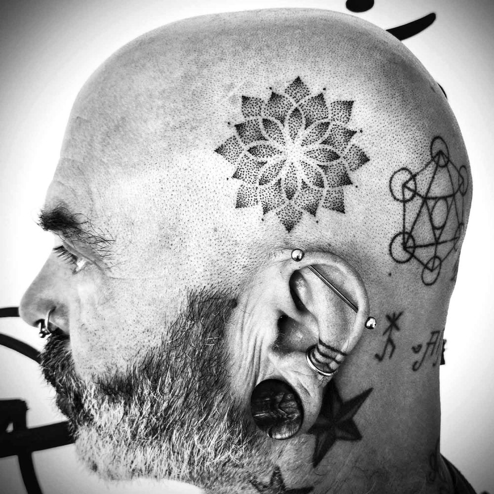 Pointillism tattoo of a flower on the head