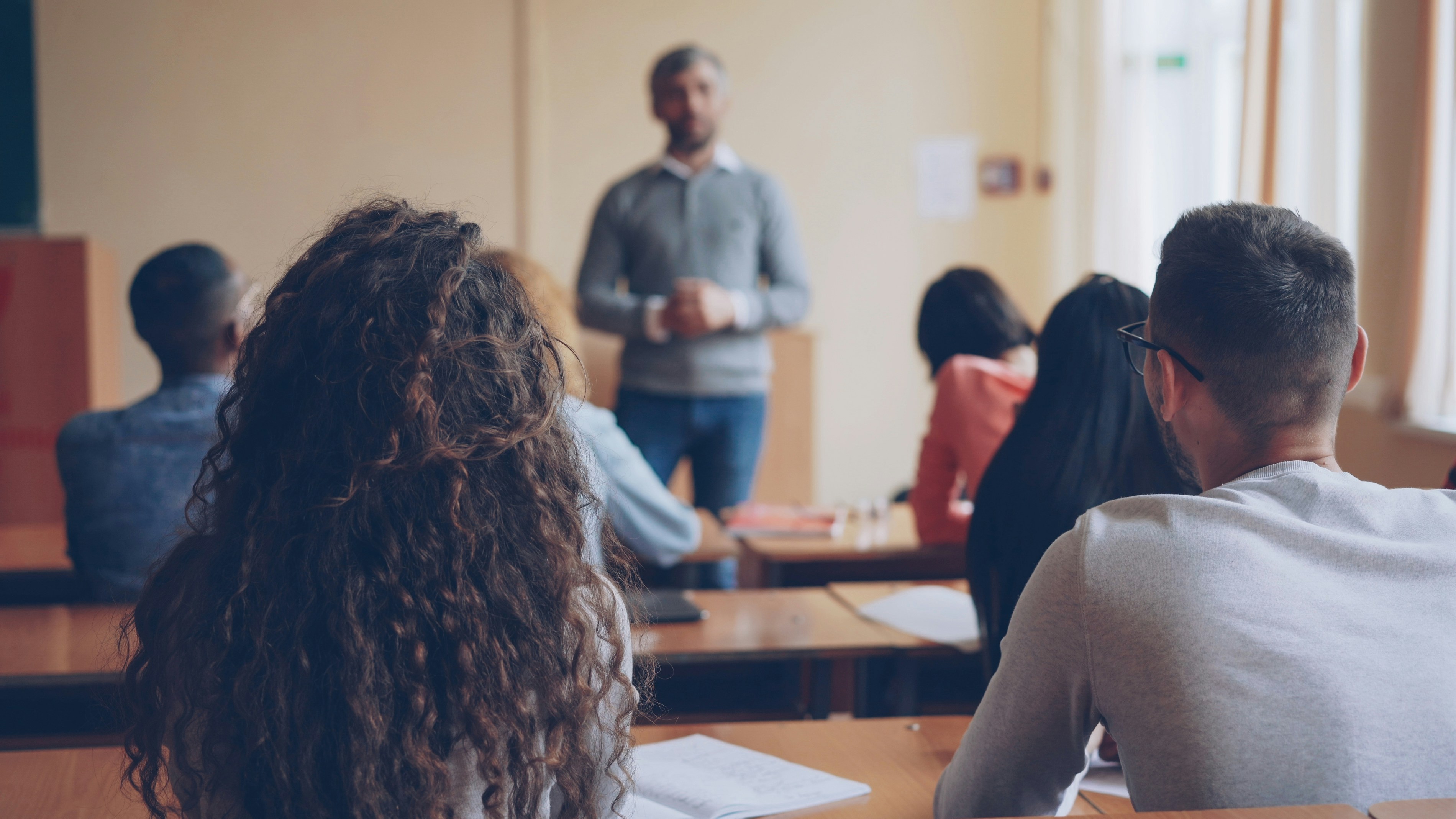 Teacher instructing students in a classroom setting