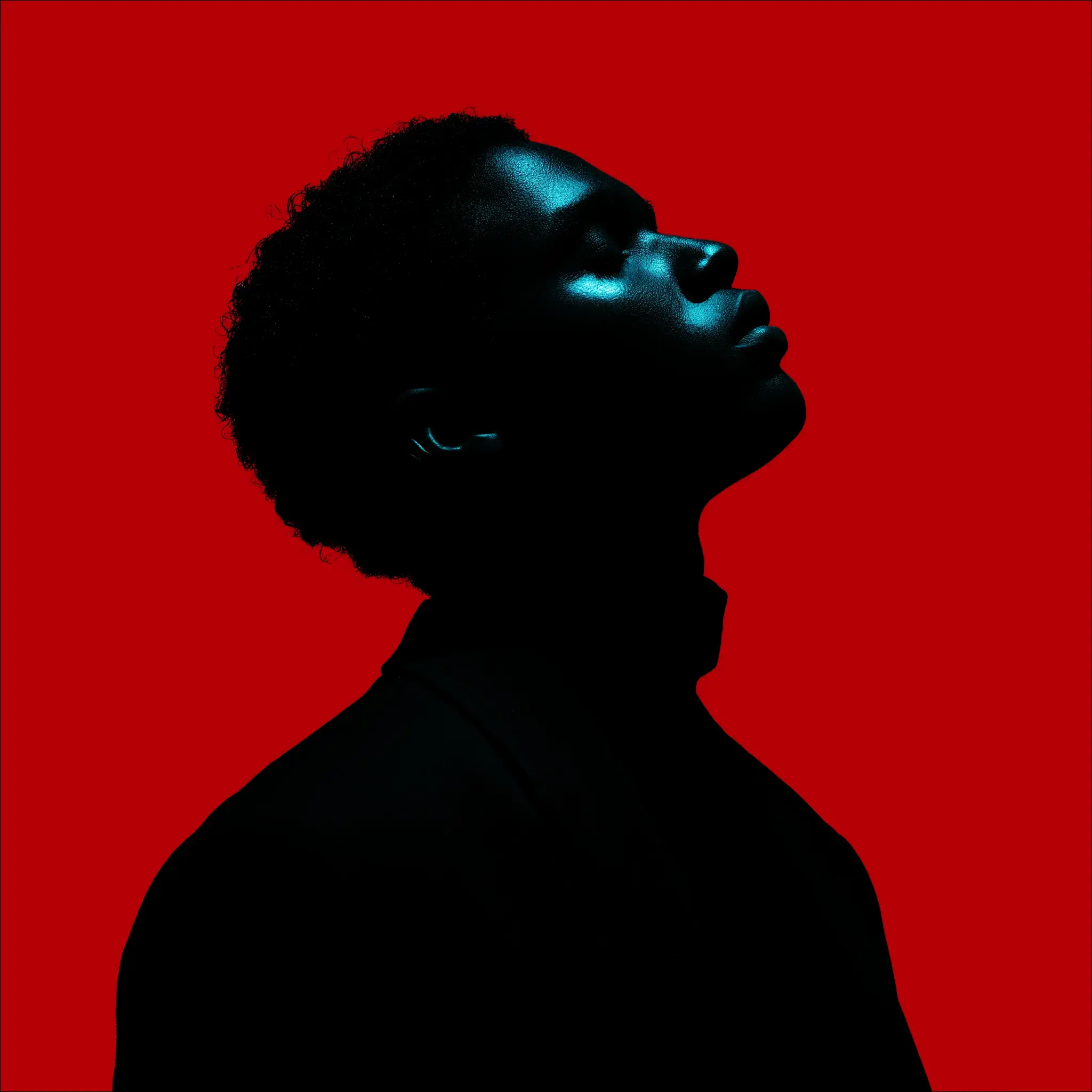 A dramatic profile photograph of a man against a vibrant red background, captured in deep shadow with striking blue light highlighting his upward-tilted face and jawline.