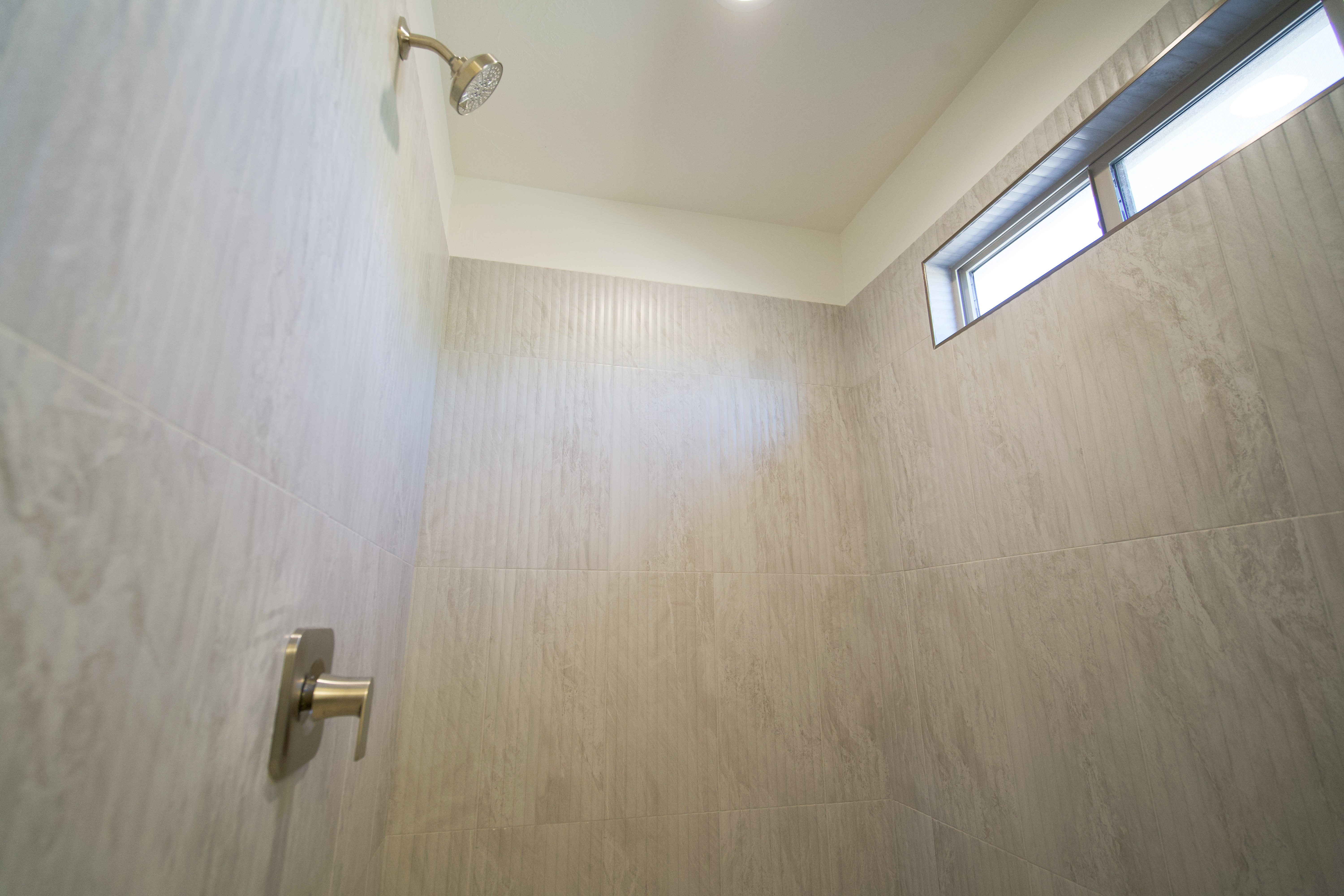 Shower area in a Hurricane, Utah remodel with clean tile and bright design.