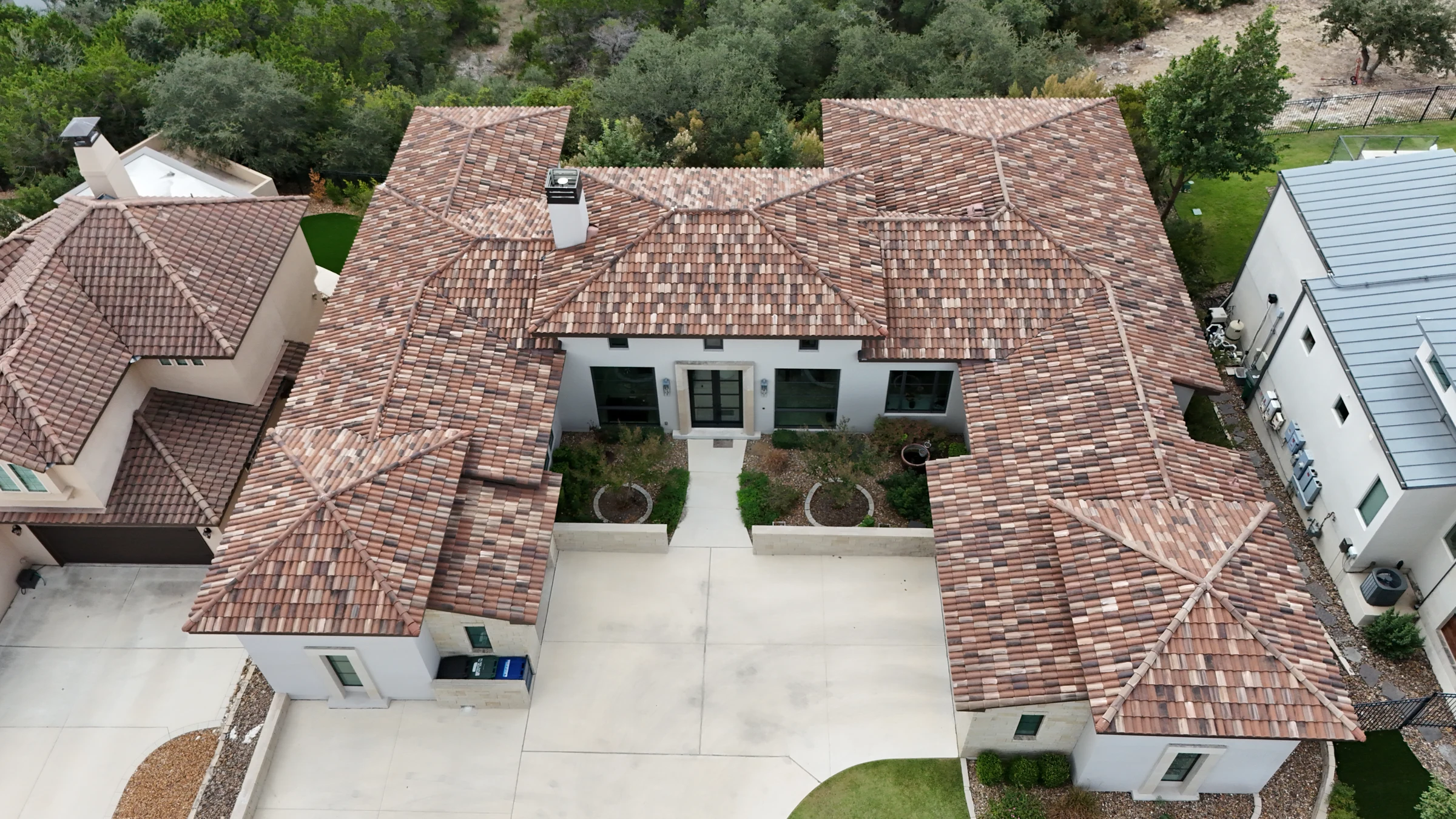 Finished multitone curved-tile roof in San Antonio, photographed from above following tile repairs.
