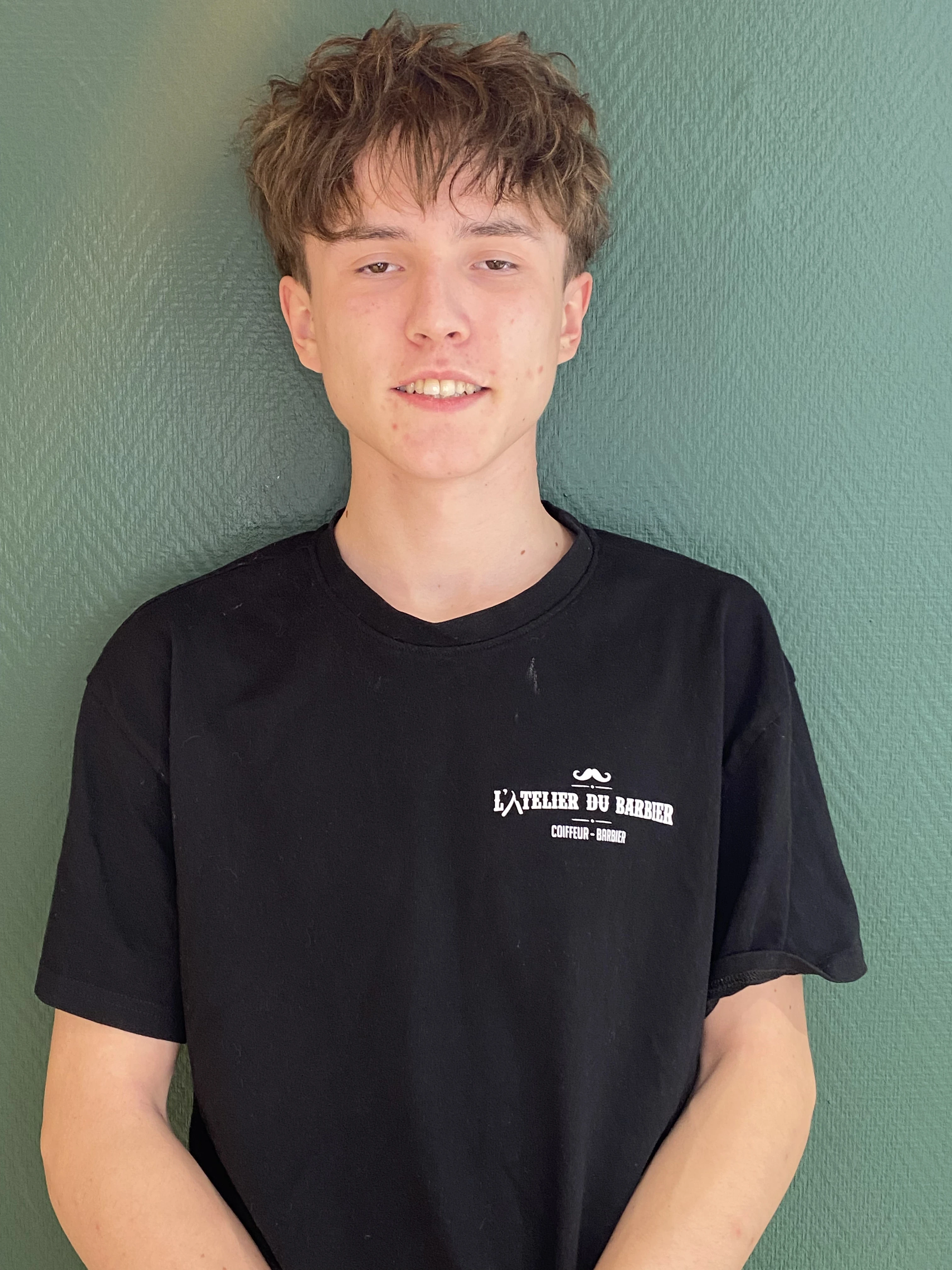 man standing near white wall