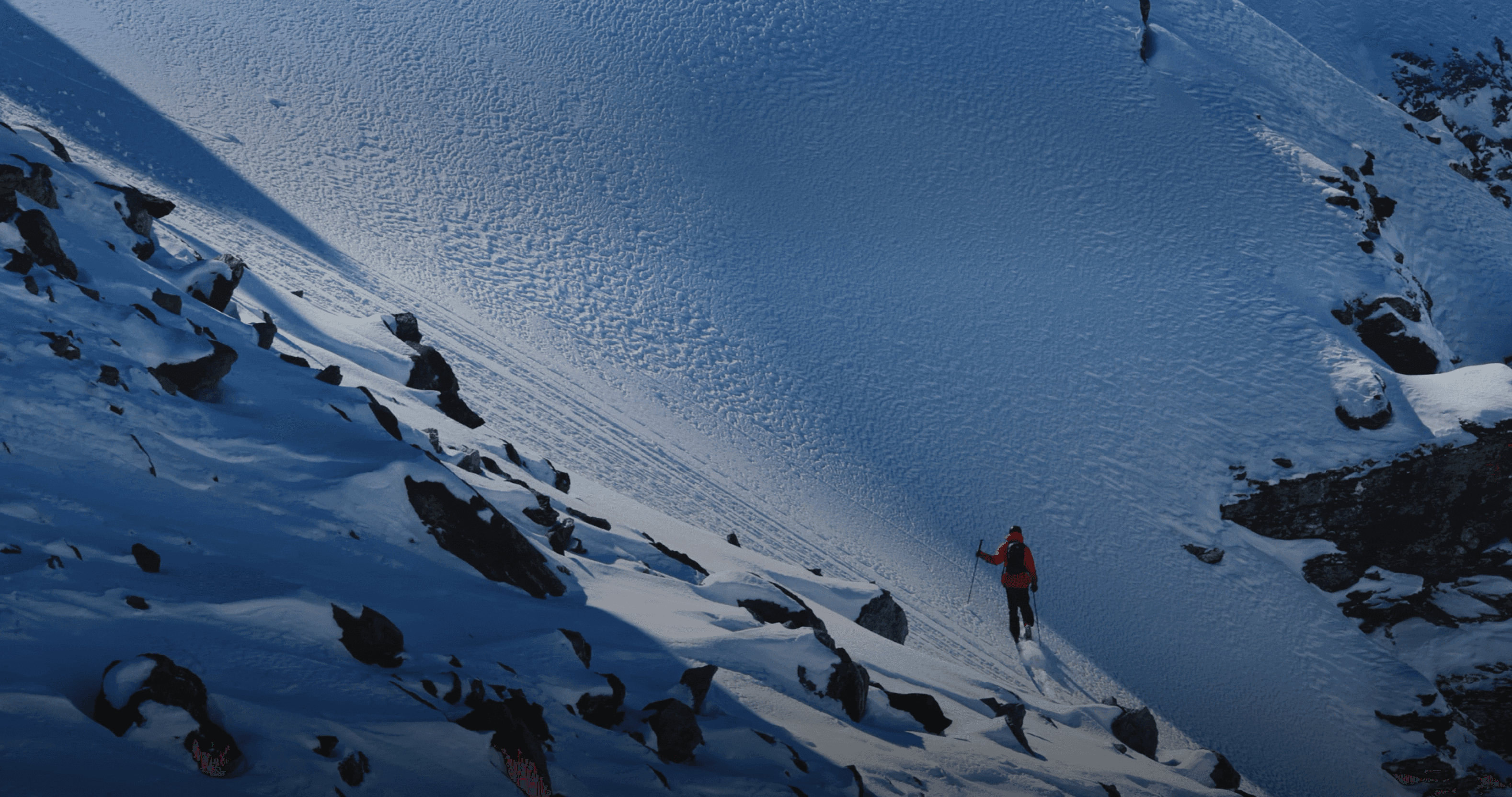 Climber ascending a snowy mountain slope