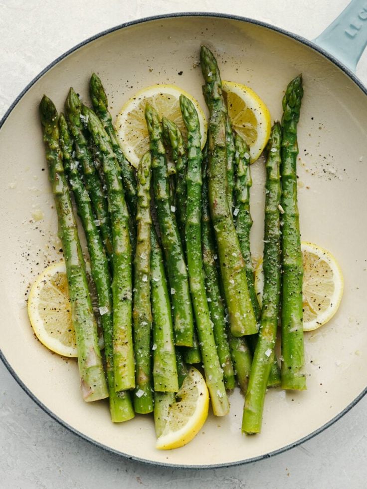Tender green asparagus spears grilled to perfection with a light char, served with lemon wedges