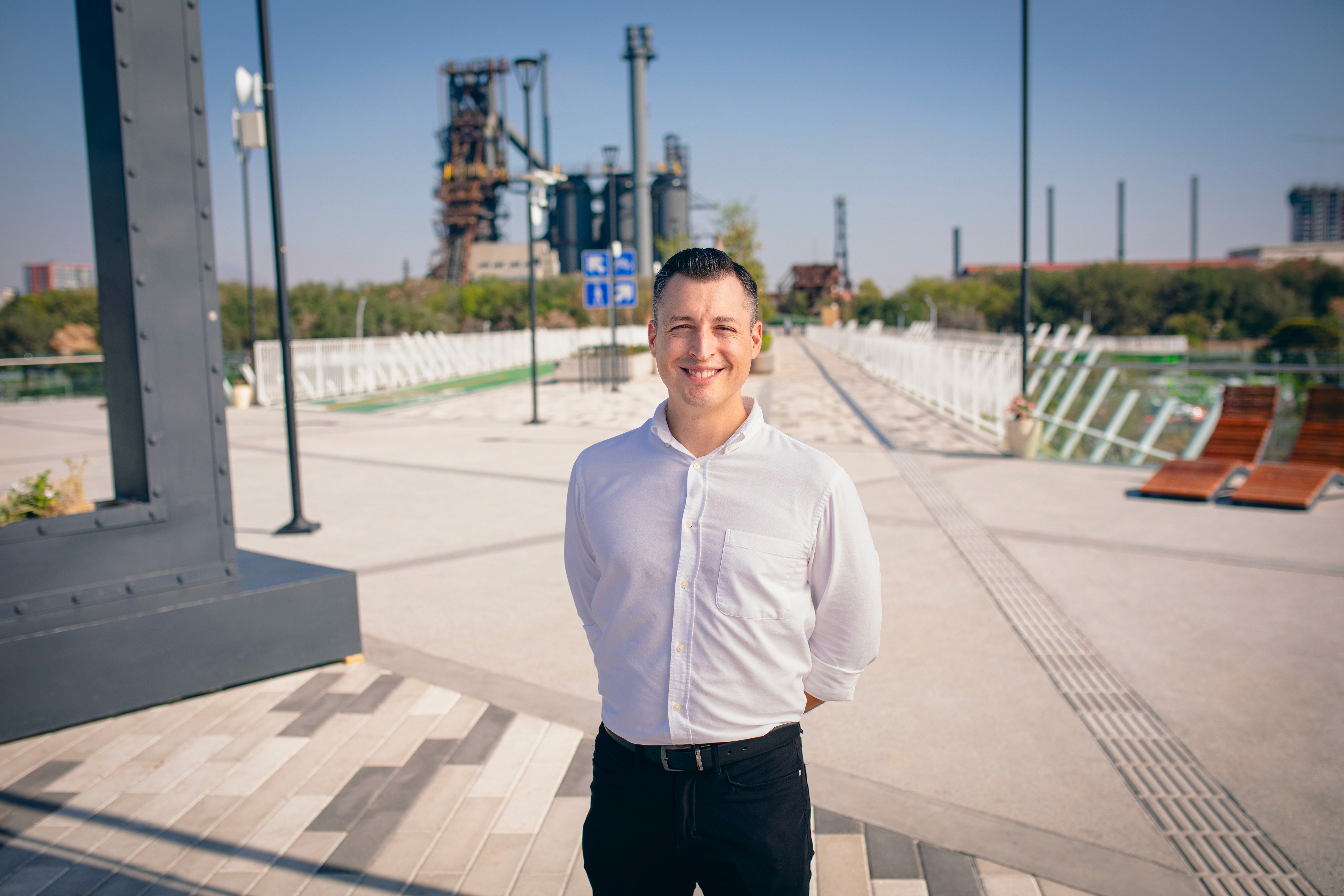 A man with long hair is working on a computer.
