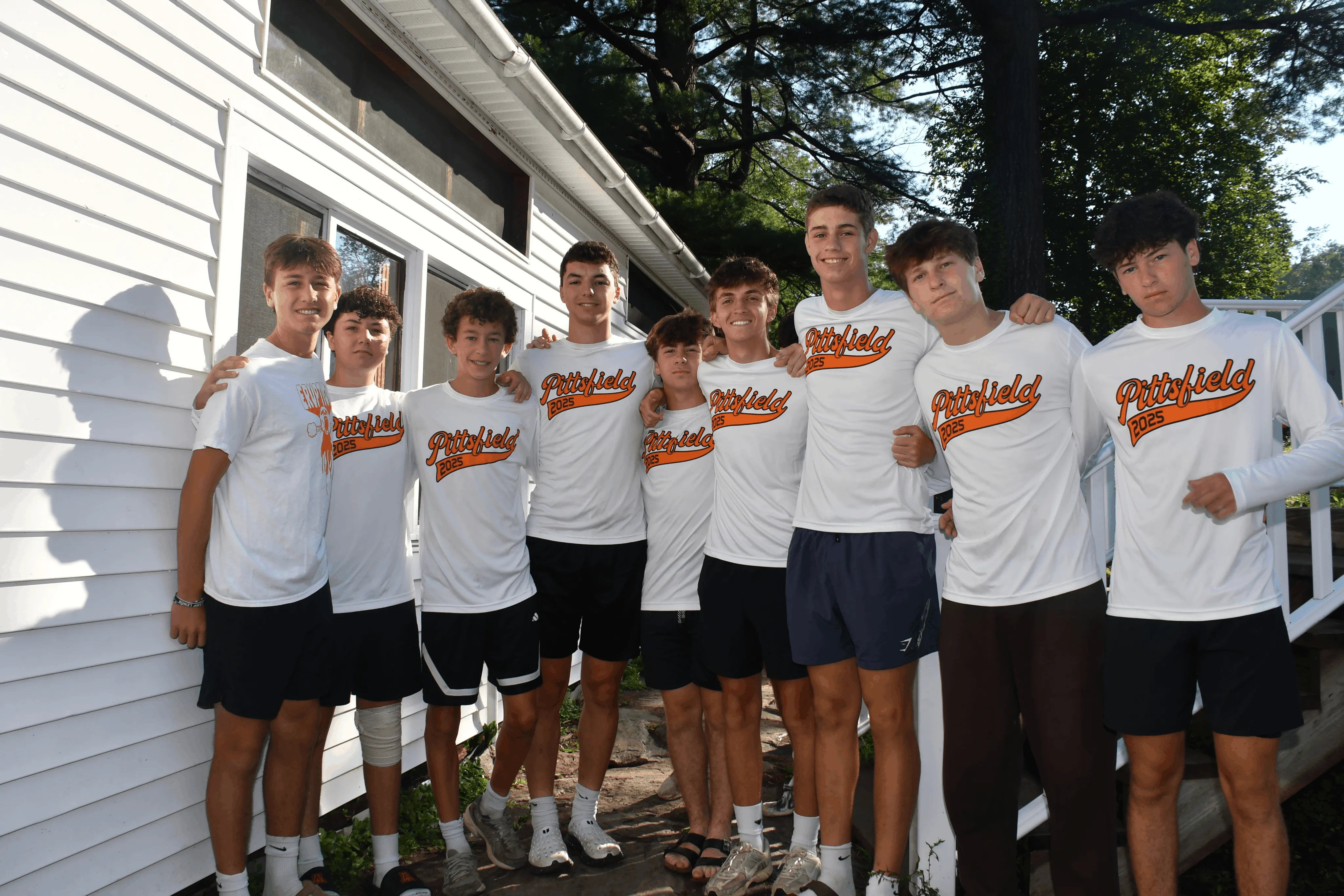 Group of campers in matching orange and white shirts at Camp Lenox