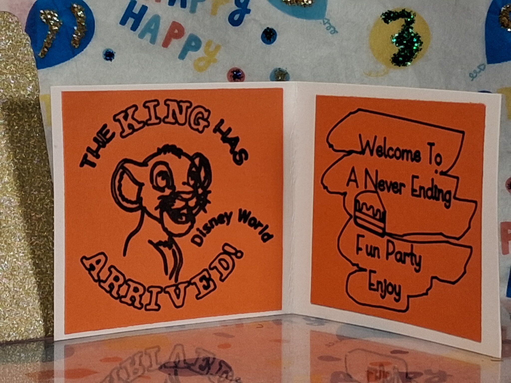 Handmade Disney Lion King birthday greeting card displayed open with “The King Has Arrived” message and party-themed design.
