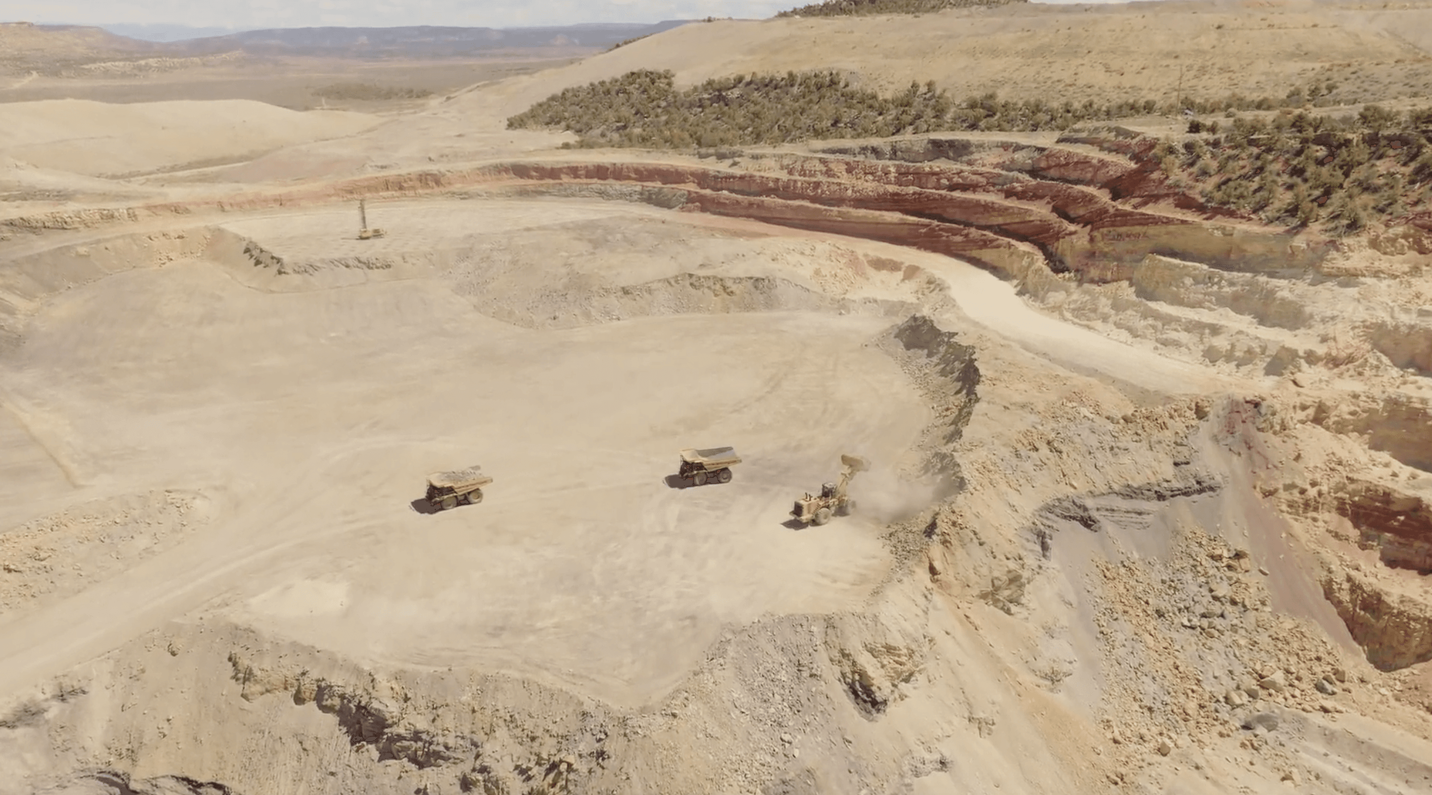 construction workers standing near wheelbarrows near mountain