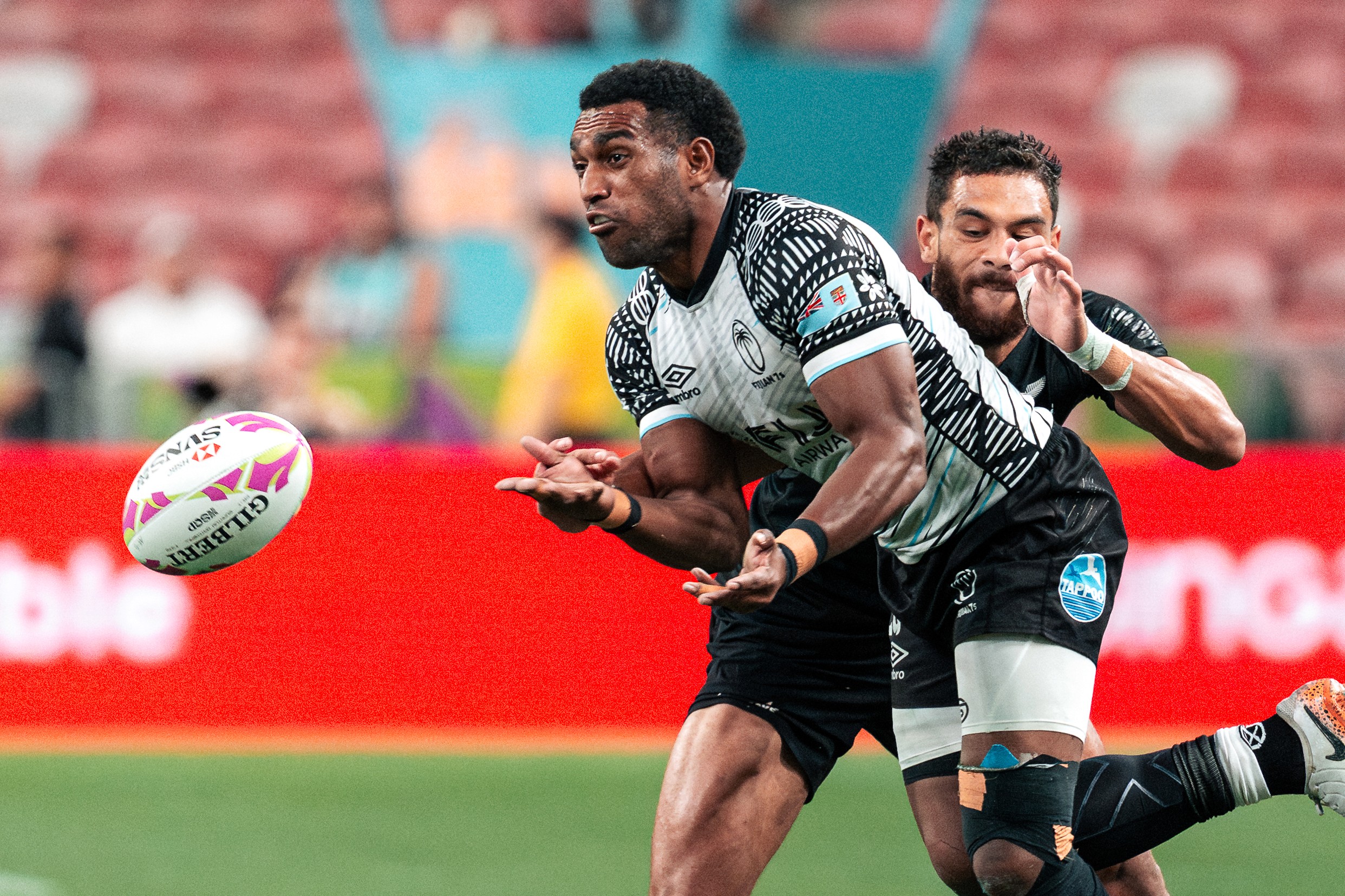 Brady Rush of the New Zealand All Blacks tackles a Joji Nasova of Fiji at the HSBC SVNS Singapore 2025