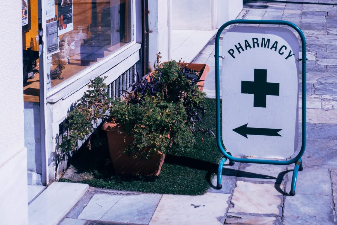 Pharmacy location green plus sign arrow