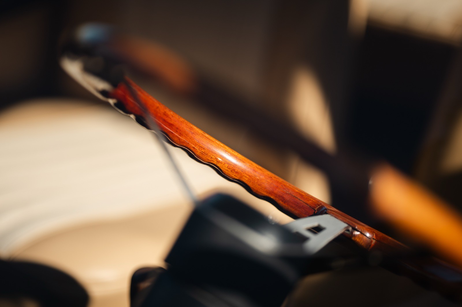Close-up of a bow resting on the strings of a musical instrument, highlighting intricate details.