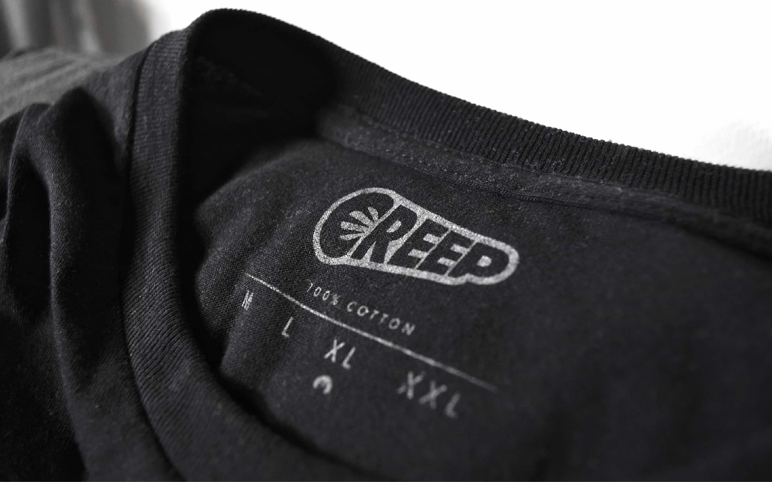 wordmark of Creep on neck label of black t-shirt, streetwear shot.