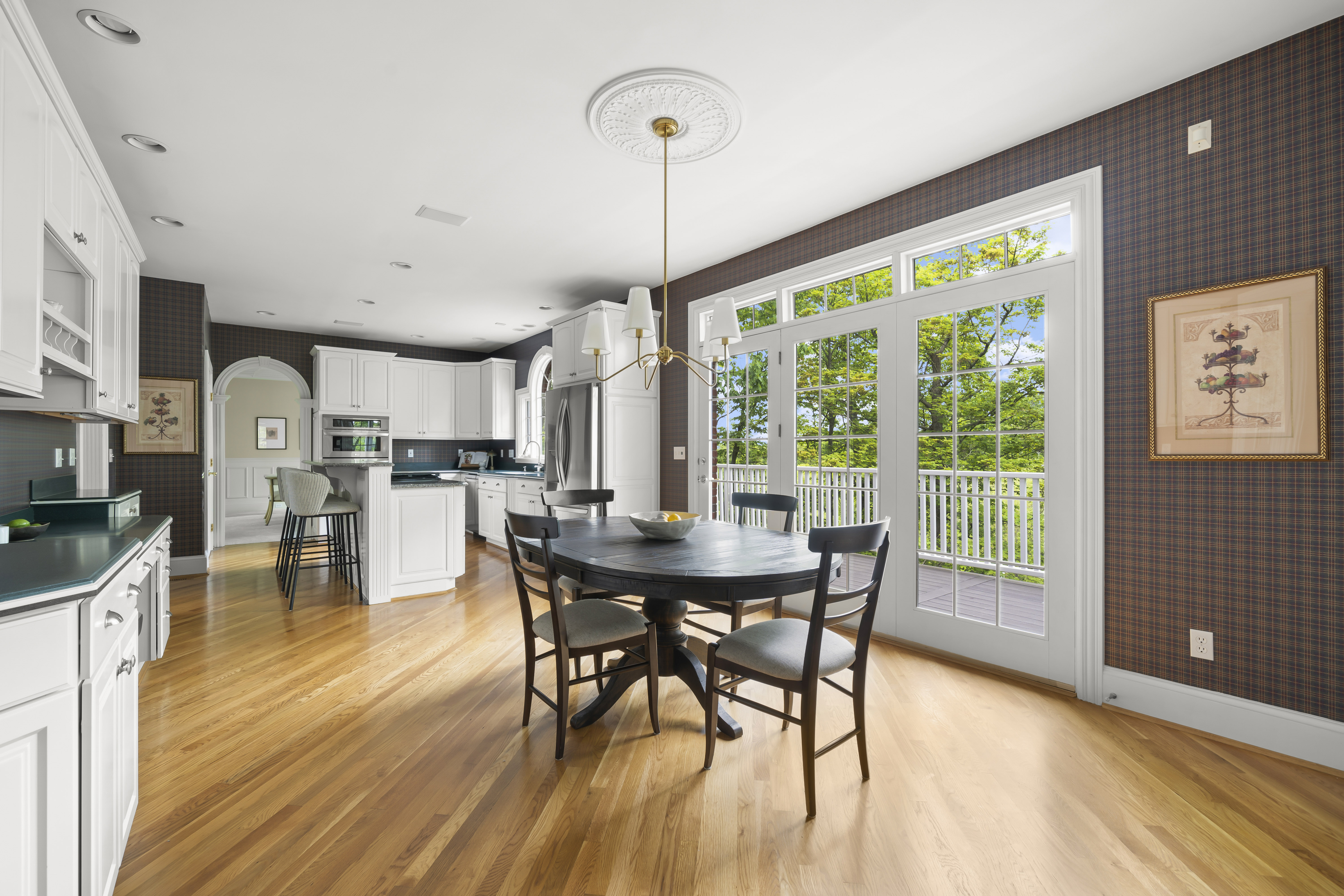 a house with a fence and trees in the background
