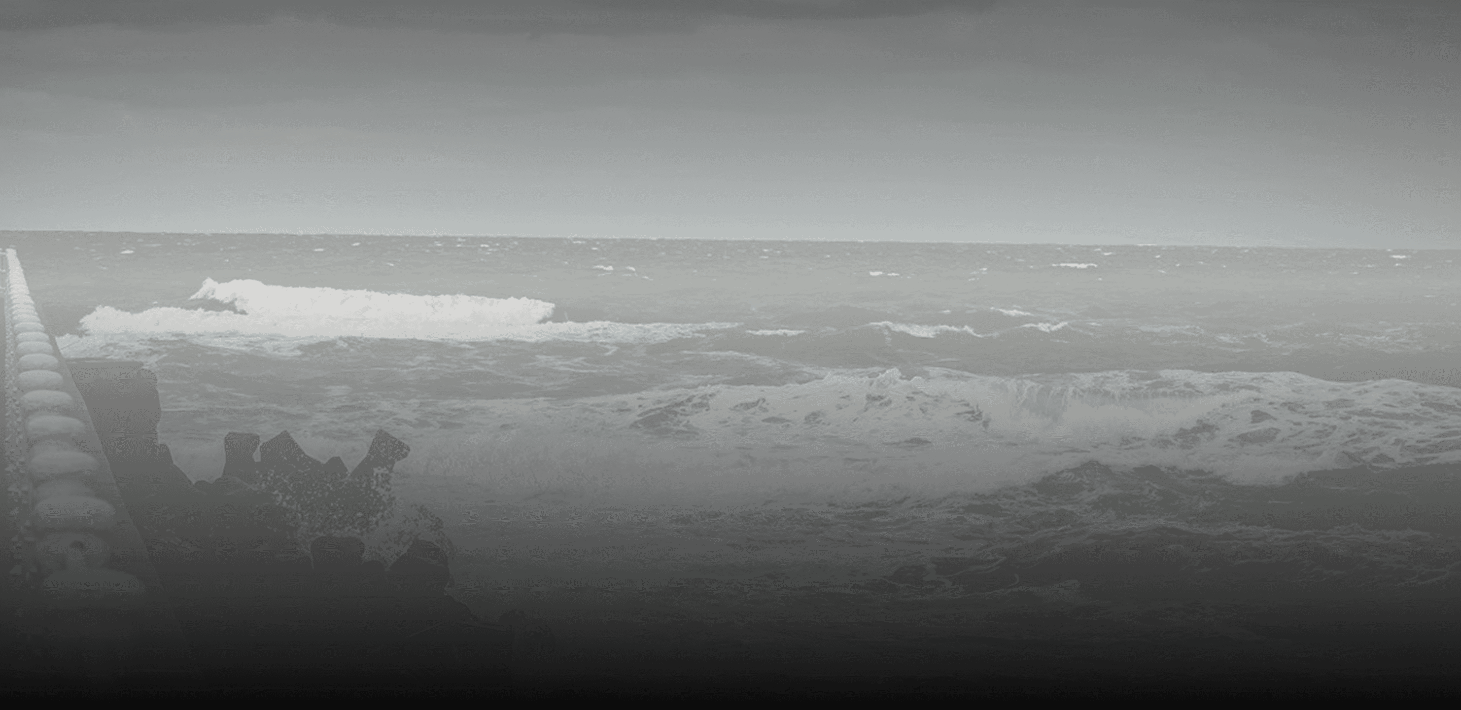A dramatic view of dark ocean waves crashing against the shore under a moody sky, serving as the hero background for The Journal blog page.