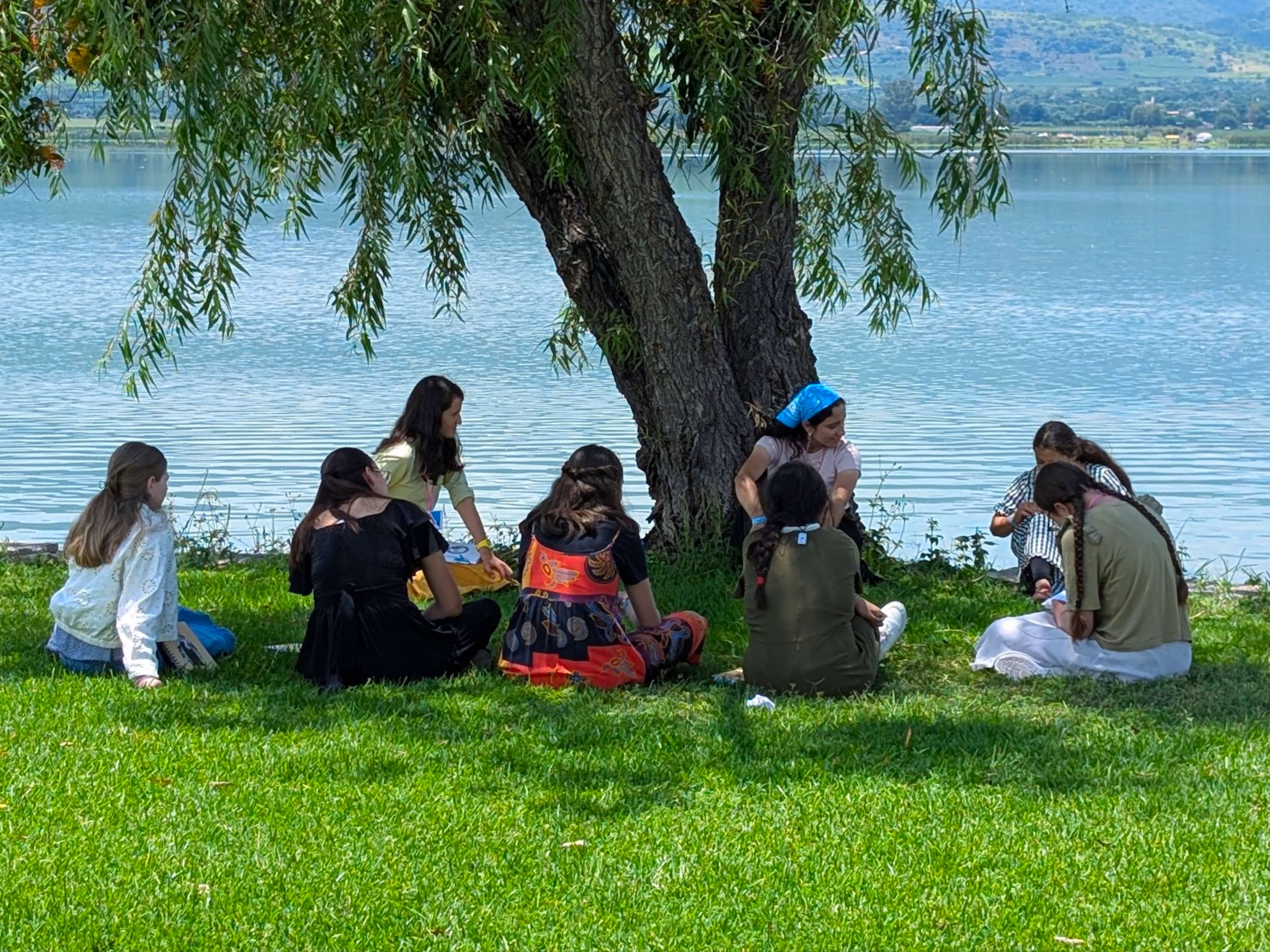 a group of children sitting on steps in front of a building